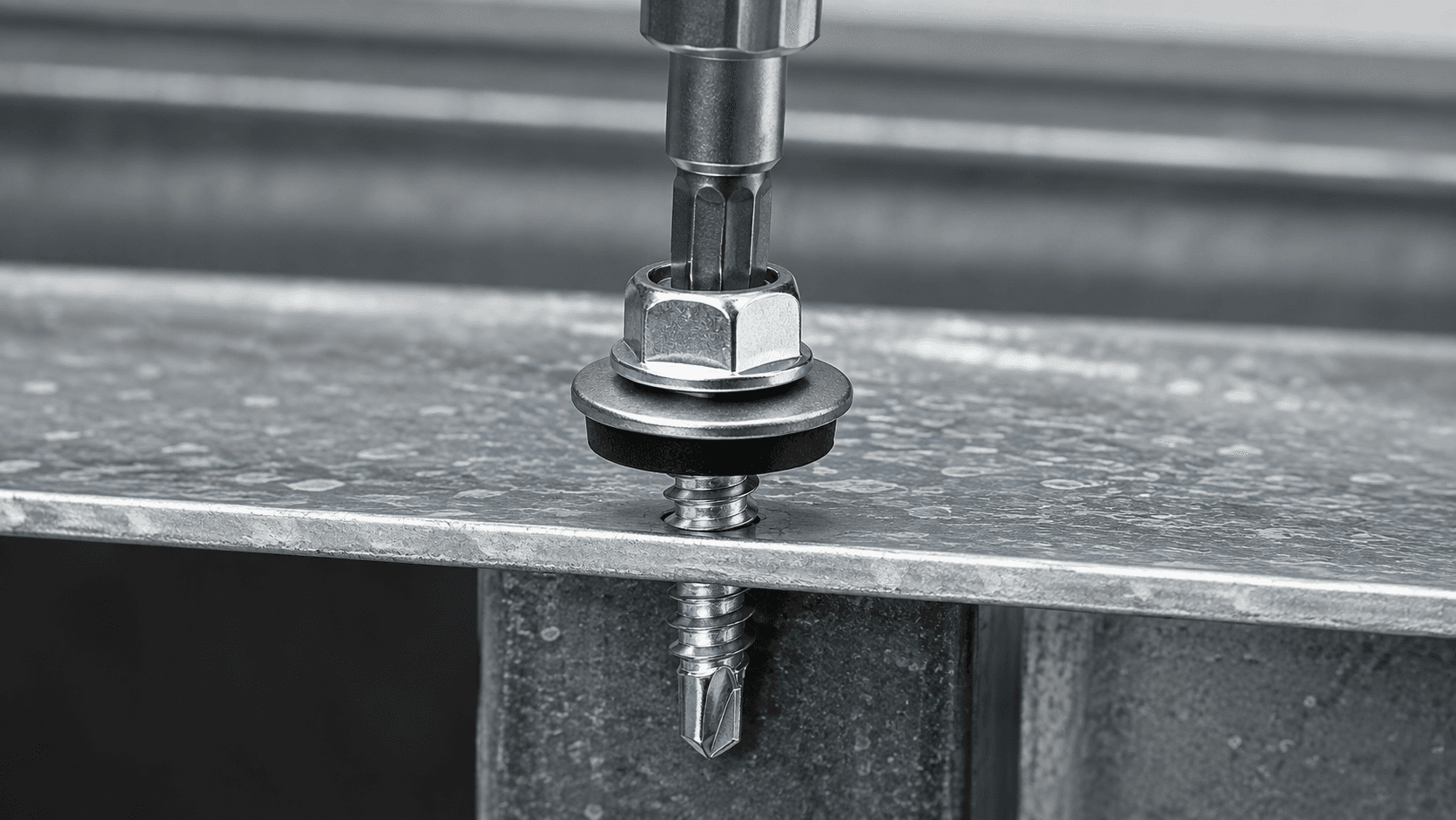 Self Drilling Screw drilling through metal sheet with hex washer head and drill point