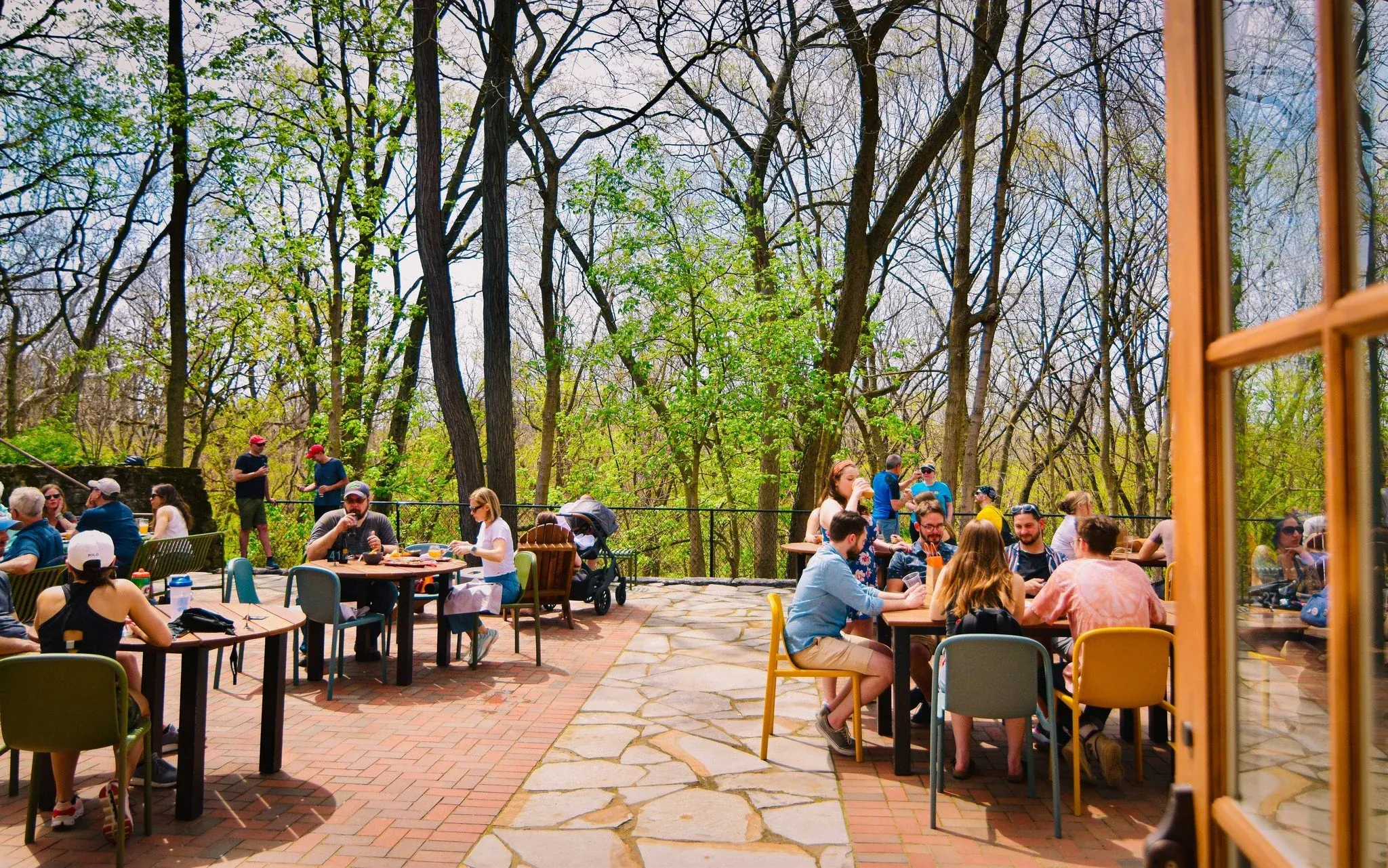 Stone patio under trees by the Olentangy Trail at Understory