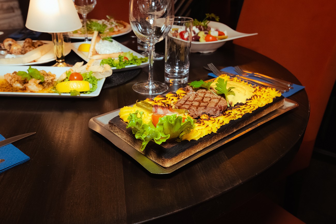 A person holding two sandwiches in their hands