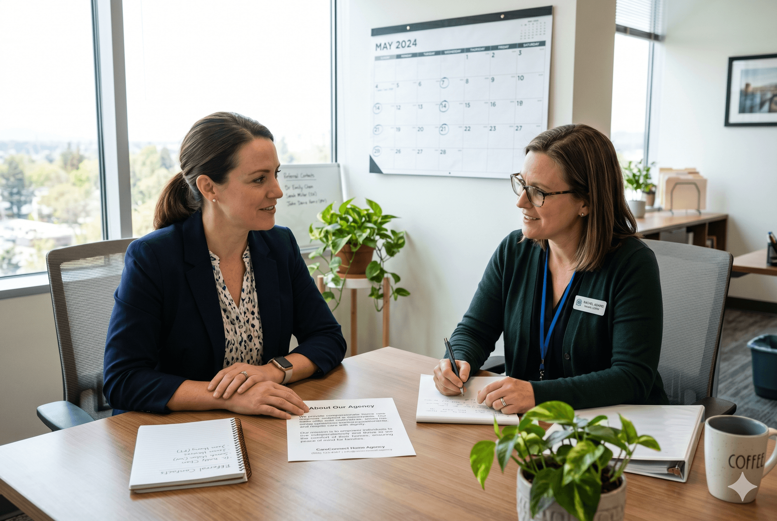 A home care agency owner and a hospital social worker discuss a document titled "About Our Agency" in a bright office. The scene includes a notepad with "Referral Contacts," a calendar with circled dates, and natural light from a window.