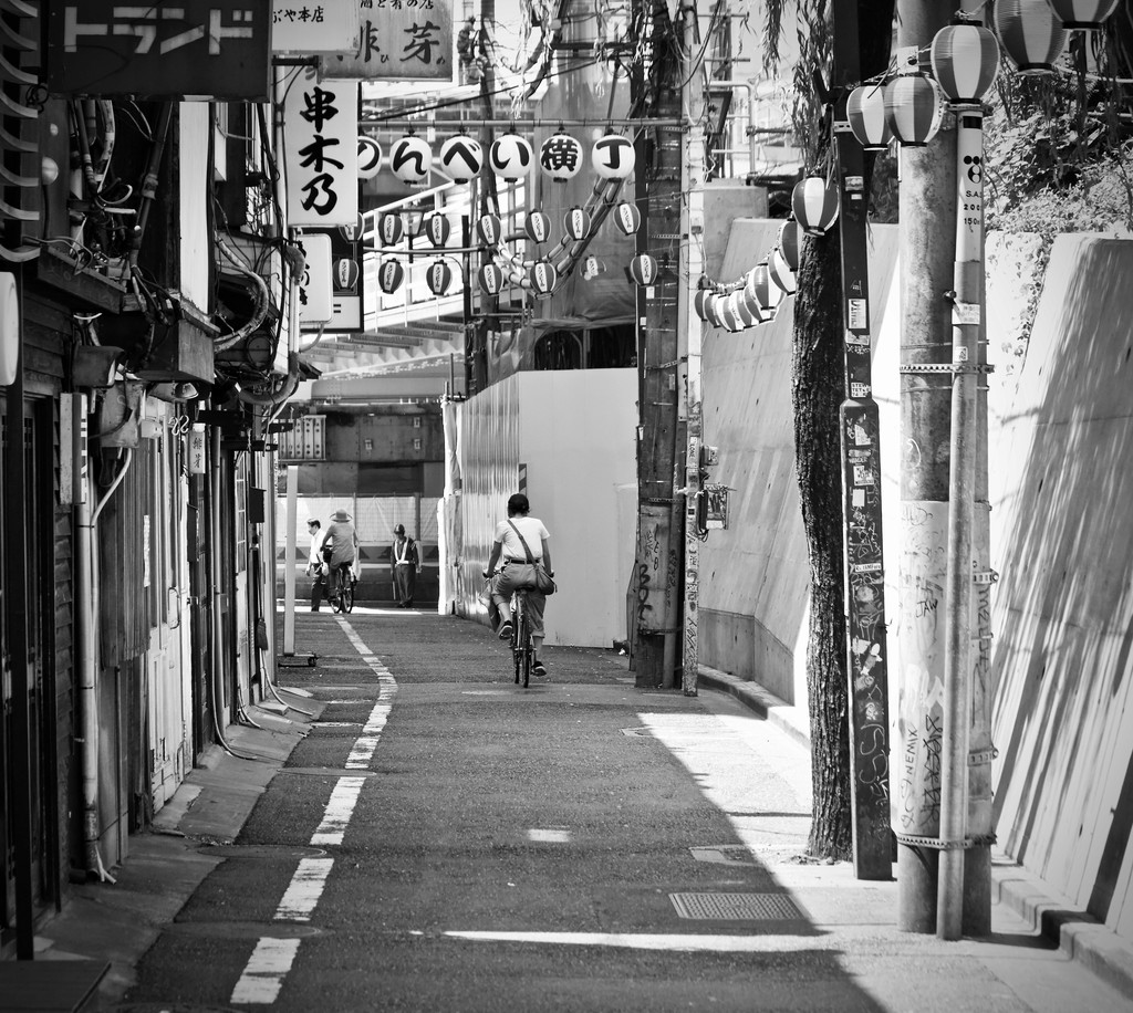 black white image showing a narrow chinese suburban street.