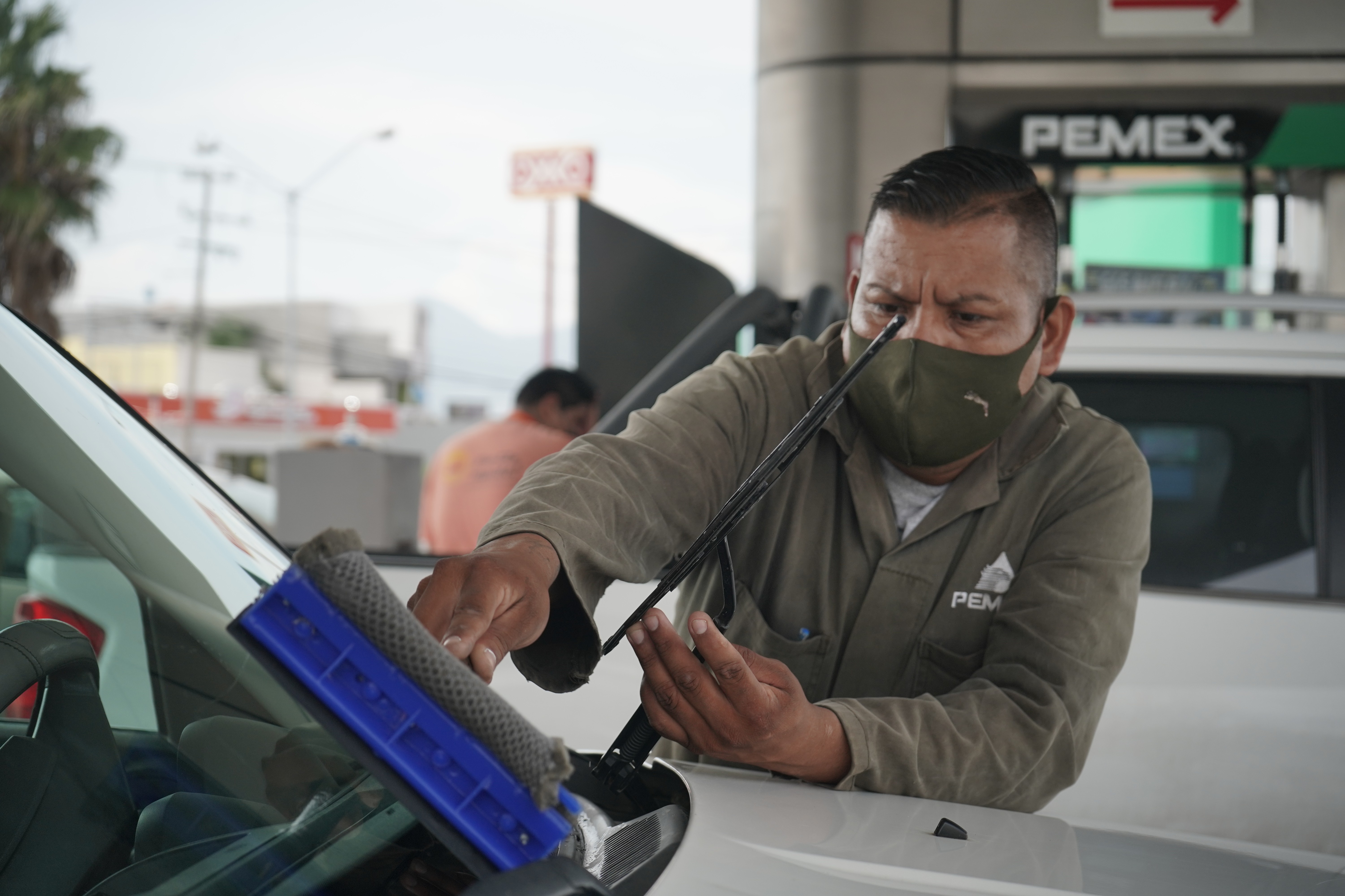 Modern bathroom featuring wooden cabinetry, a bathtub, a sleek sink, and natural light from a window.