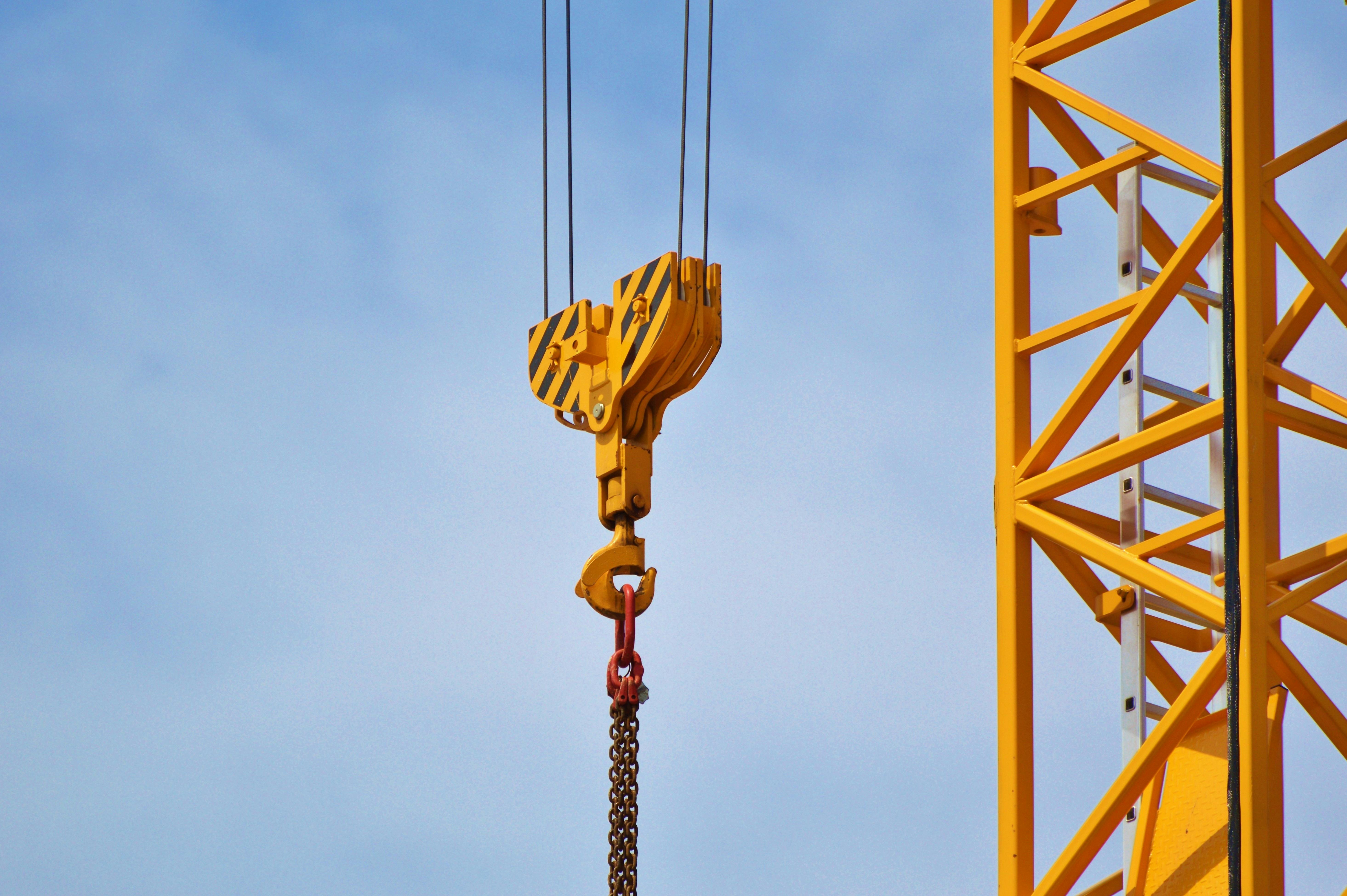 a group of cranes next to a building under construction