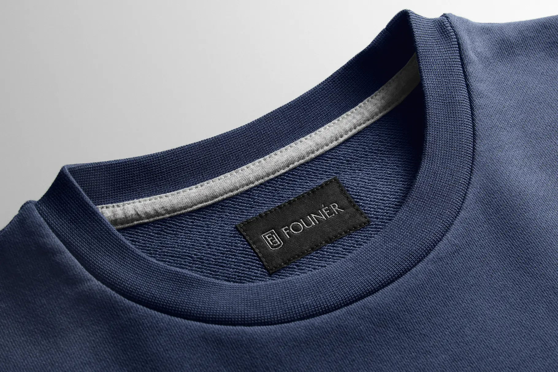 Sweatshirt label mockup featuring realistic fabric texture, clothing branding details, and premium garment presentation.