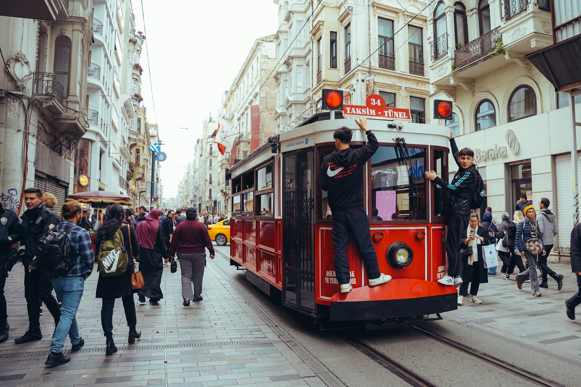 Istiklal Street in Beyoğlu with the historic red tram and lively crowds in Istanbul