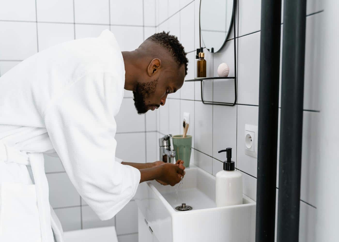 Stimulating beard growth - Man washing his face with water
