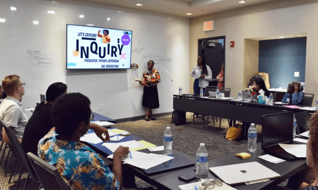 White branded cap with turquoise logo placed on fresh lemons in a red bowl