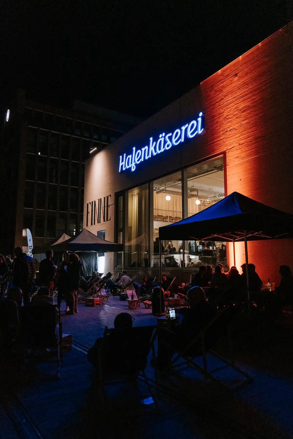 Finne Hafenbrauerei Münster bei Nacht während des Openings mit Gästen vor der beleuchteten Location