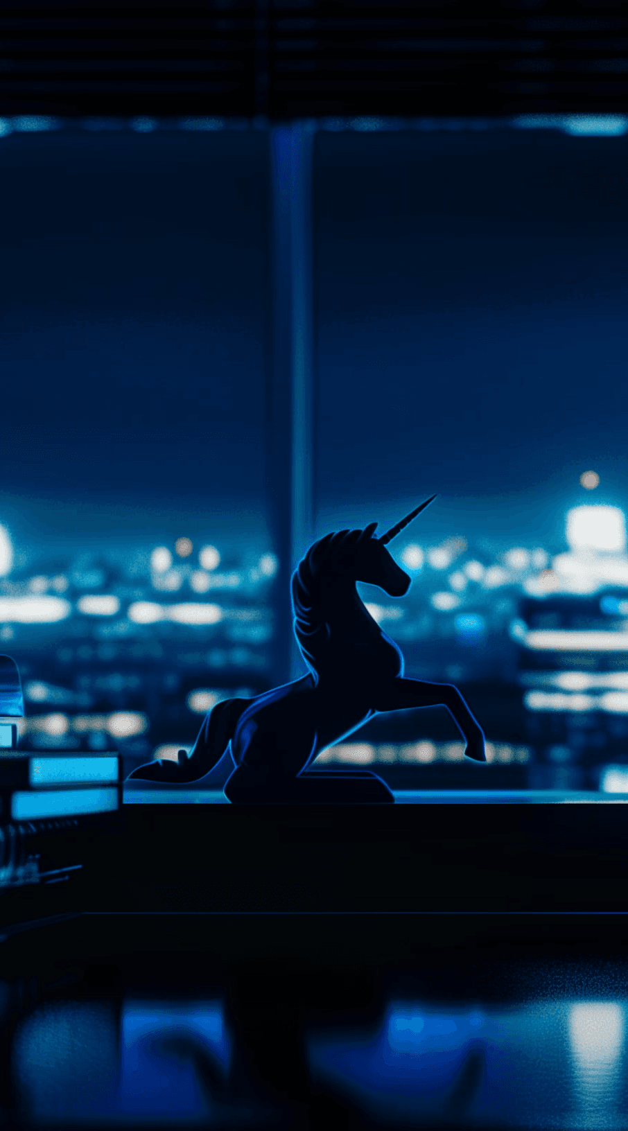 a unicorn statue in an office at night