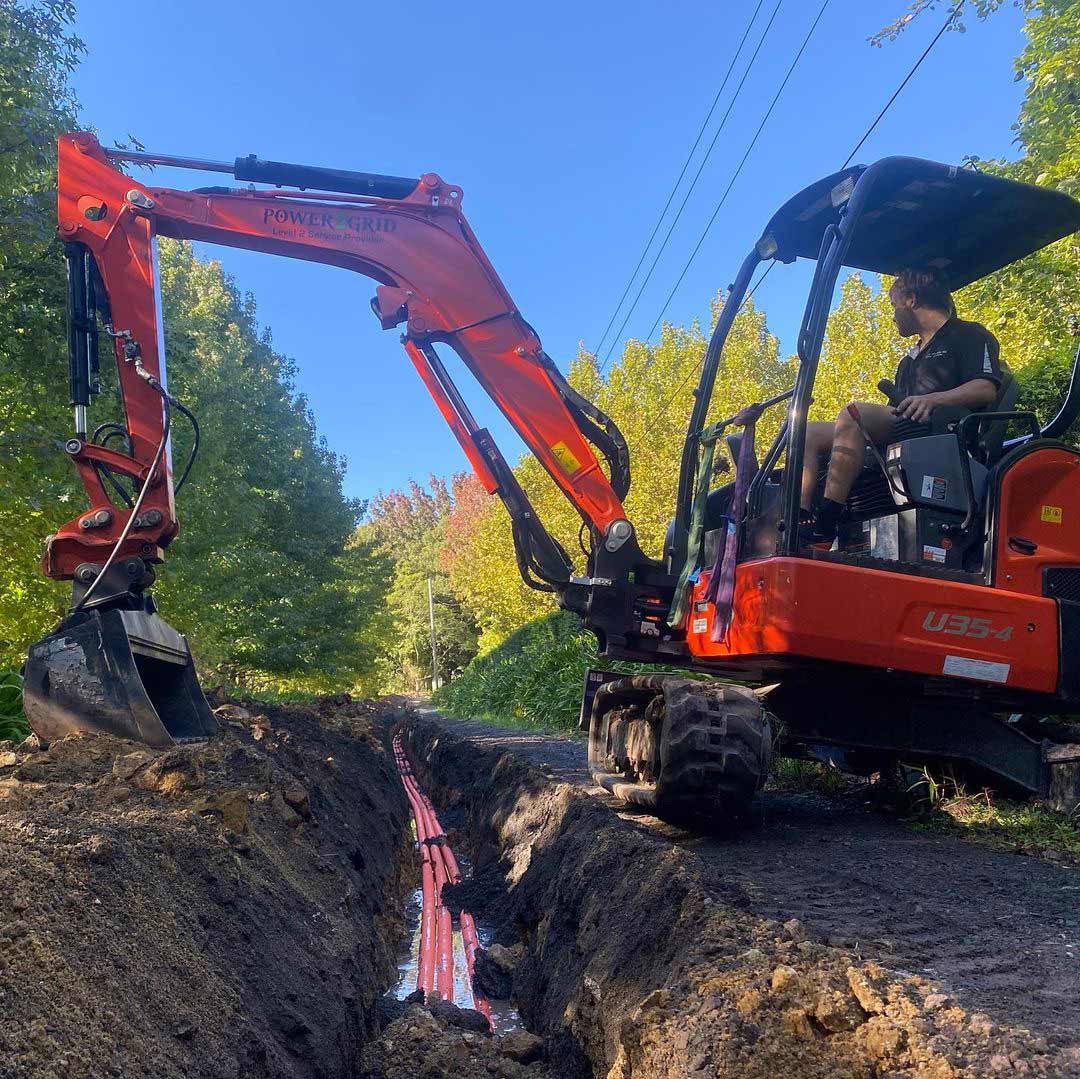 An image of a Power2grid worker laying underground pipes