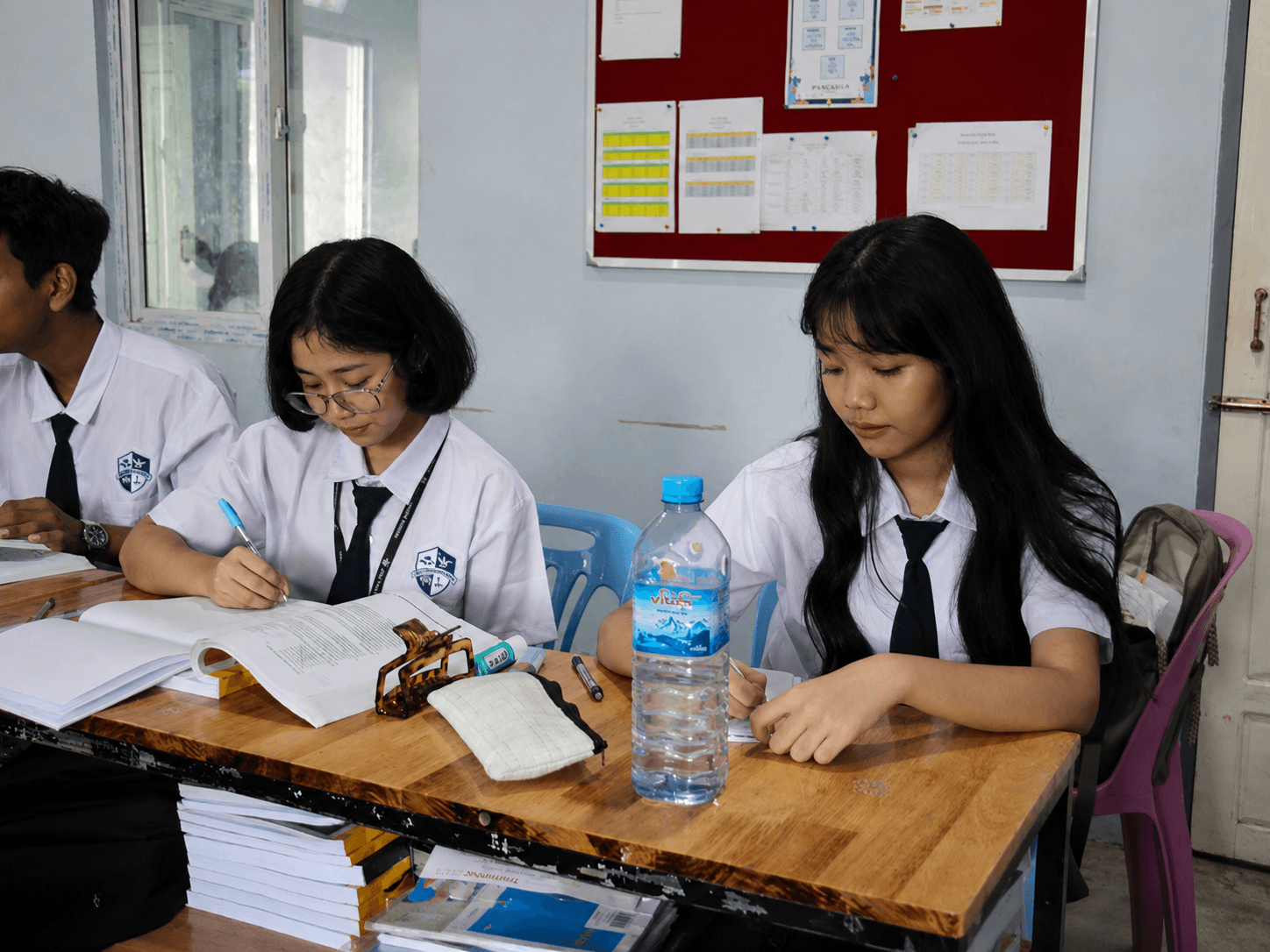 Grade 9-12 years students at Elpis International School working together on a coloring activity in Yangon, Myanmar