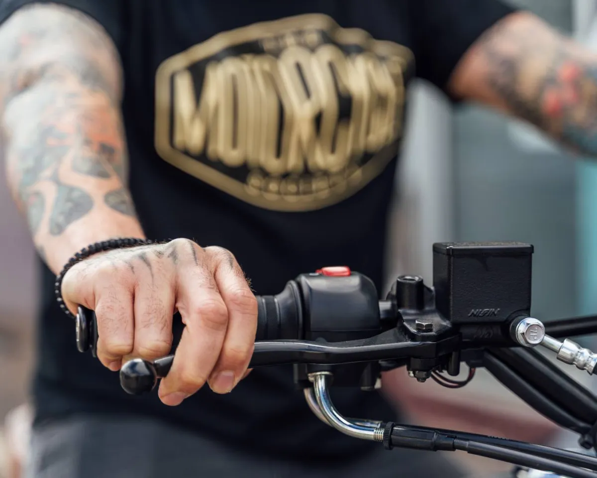 Man Wearing Motorcycle Society T-shirt riding motorcycle