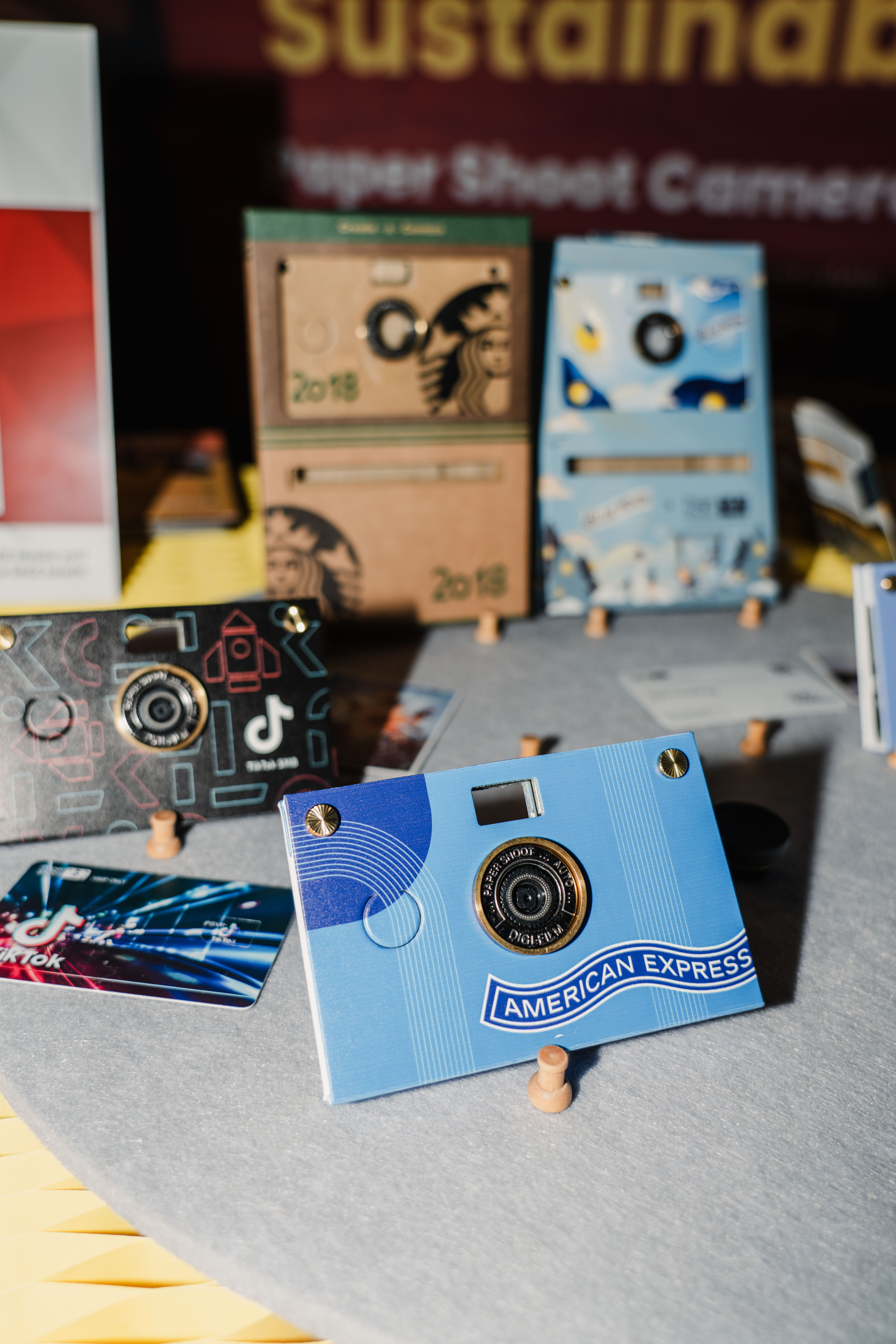 Multiple papershoot cameras taken with flash photography, that are branded for multiple brands such as tiktok.