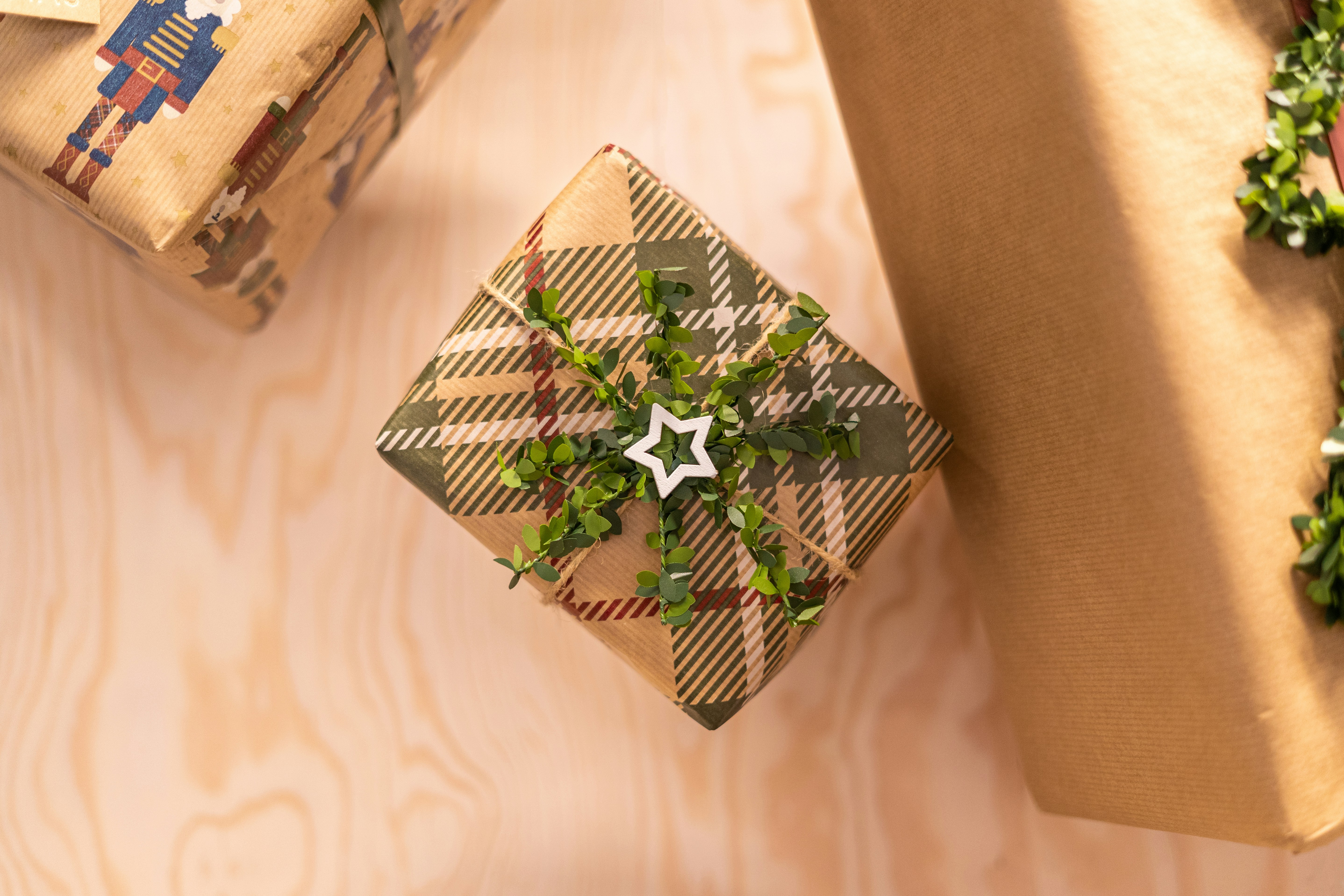 two wrapped presents sitting on top of a wooden table