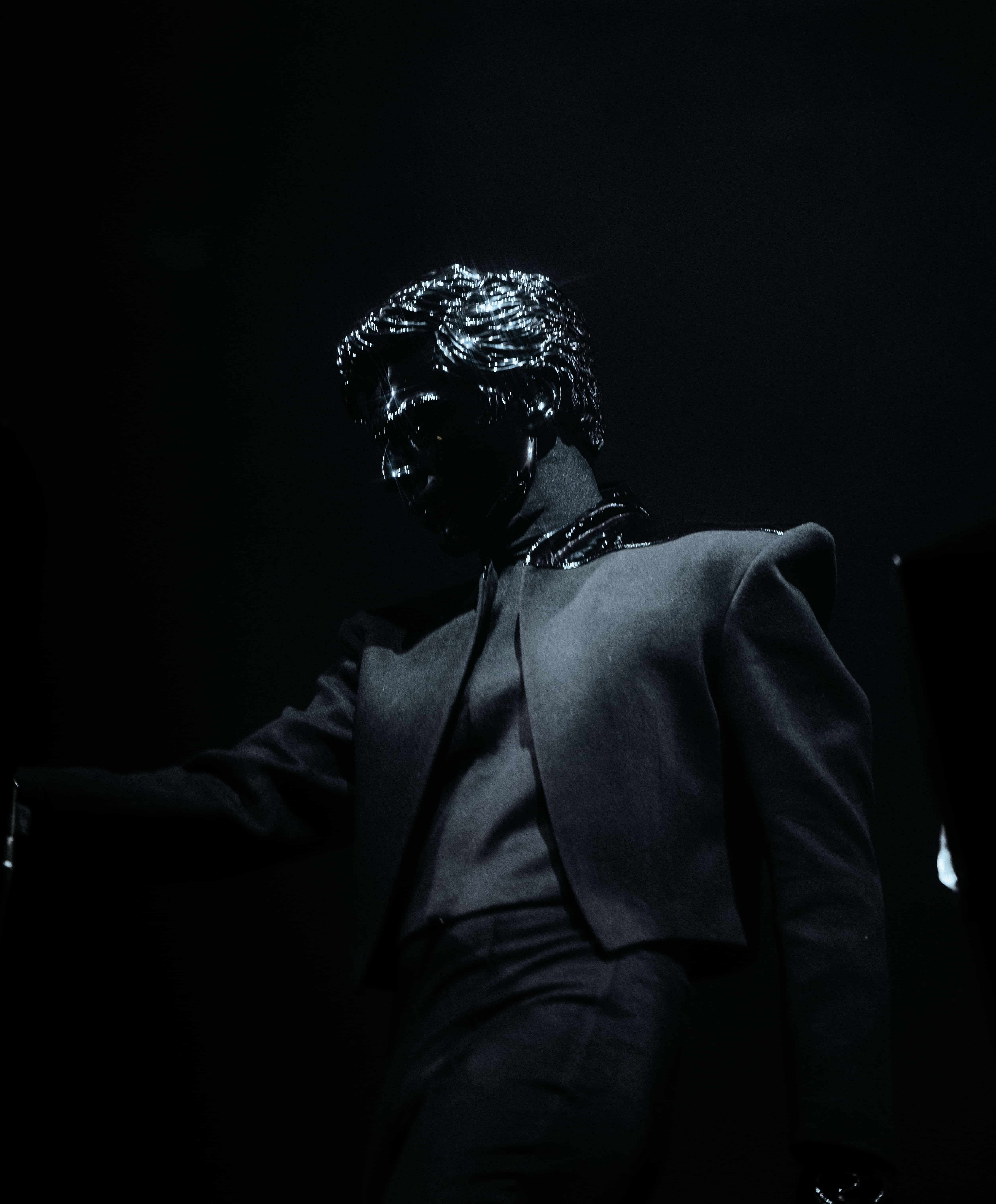 Gesaffelstein performing at Coachella 2024 wearing reflective mask and tailored black outfit under low key lighting, captured by A World Away creative director Brandon Densley