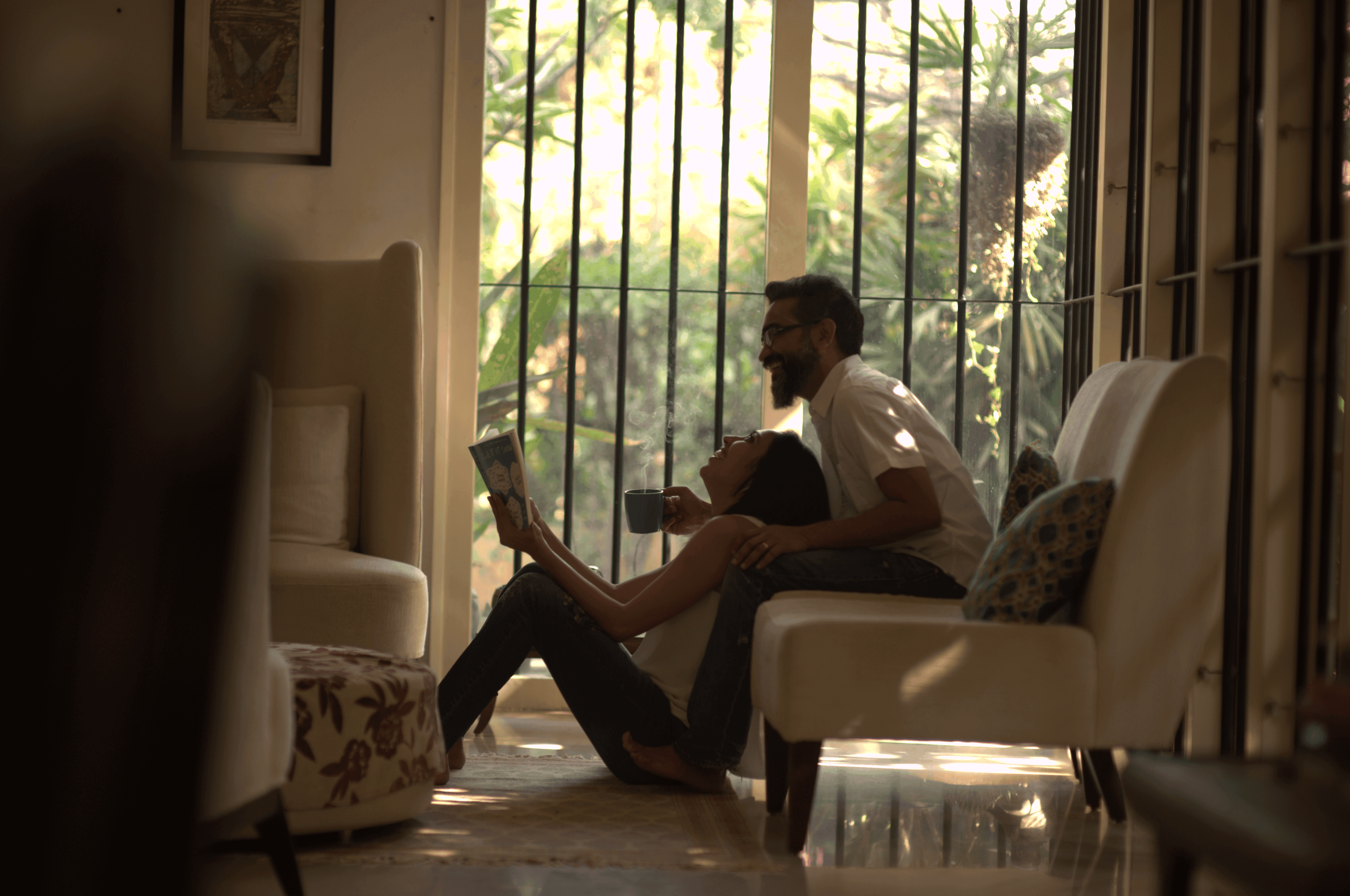 A bride and groom share a kiss surrounded by a joyful bridal party.