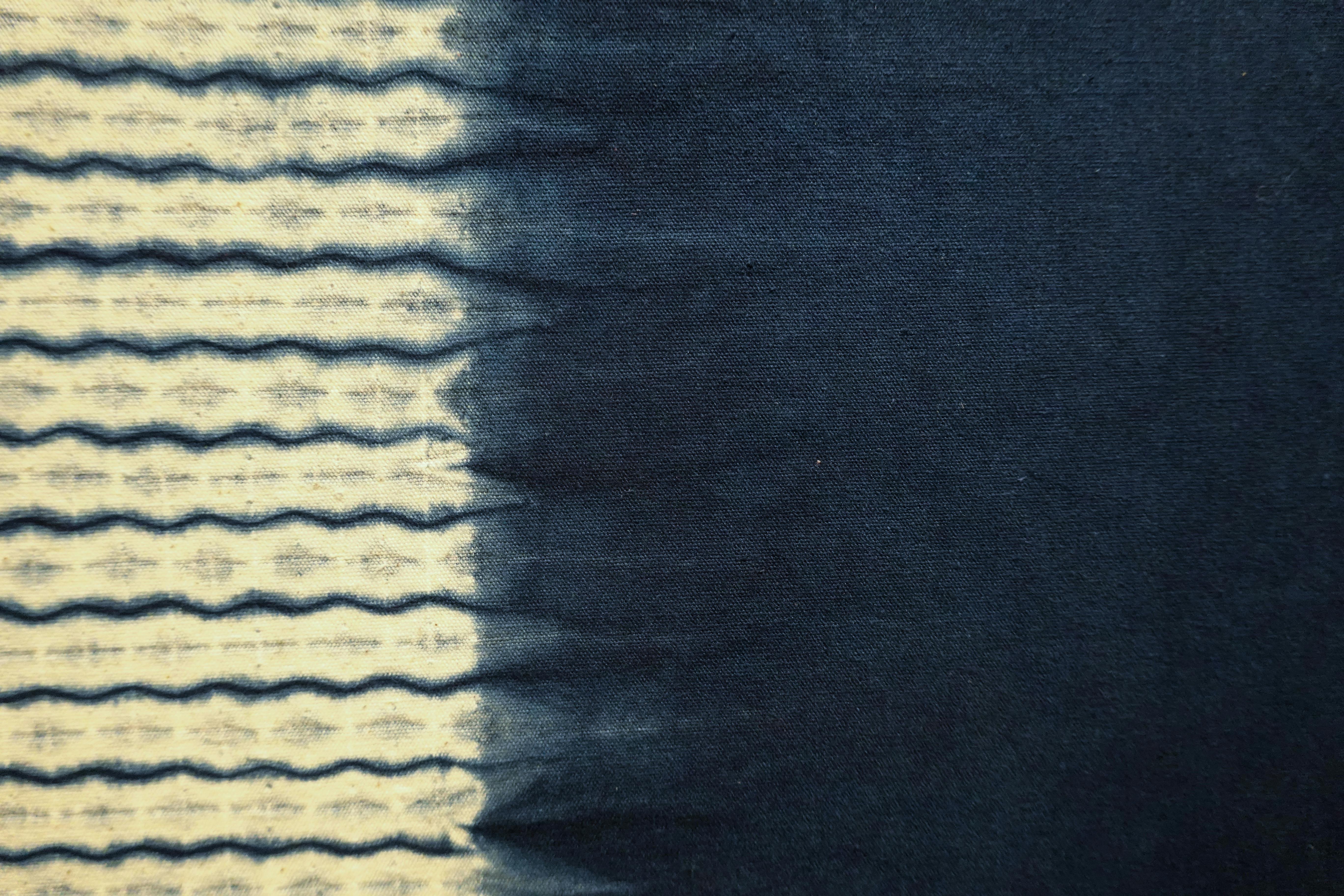 Abstract fabric texture with stitched and dyed patterns