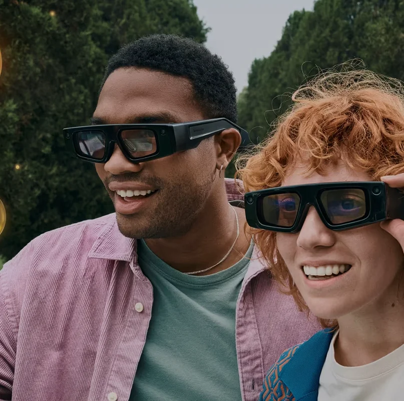 Two people wearing Snap Spectacles AR smart glasses wearable camera technology for social augmented reality experiences