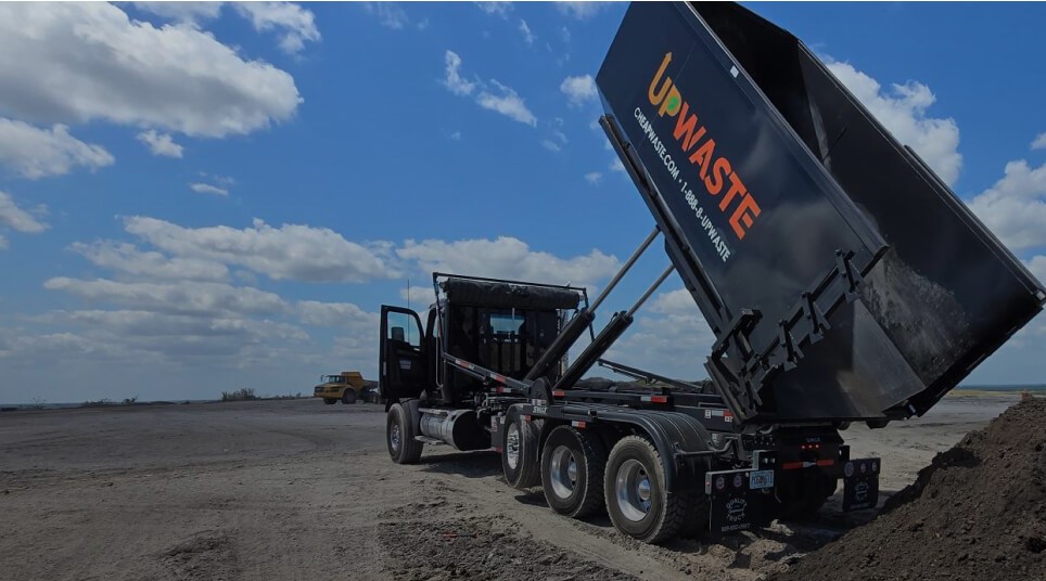Dumpster truck unloading soil