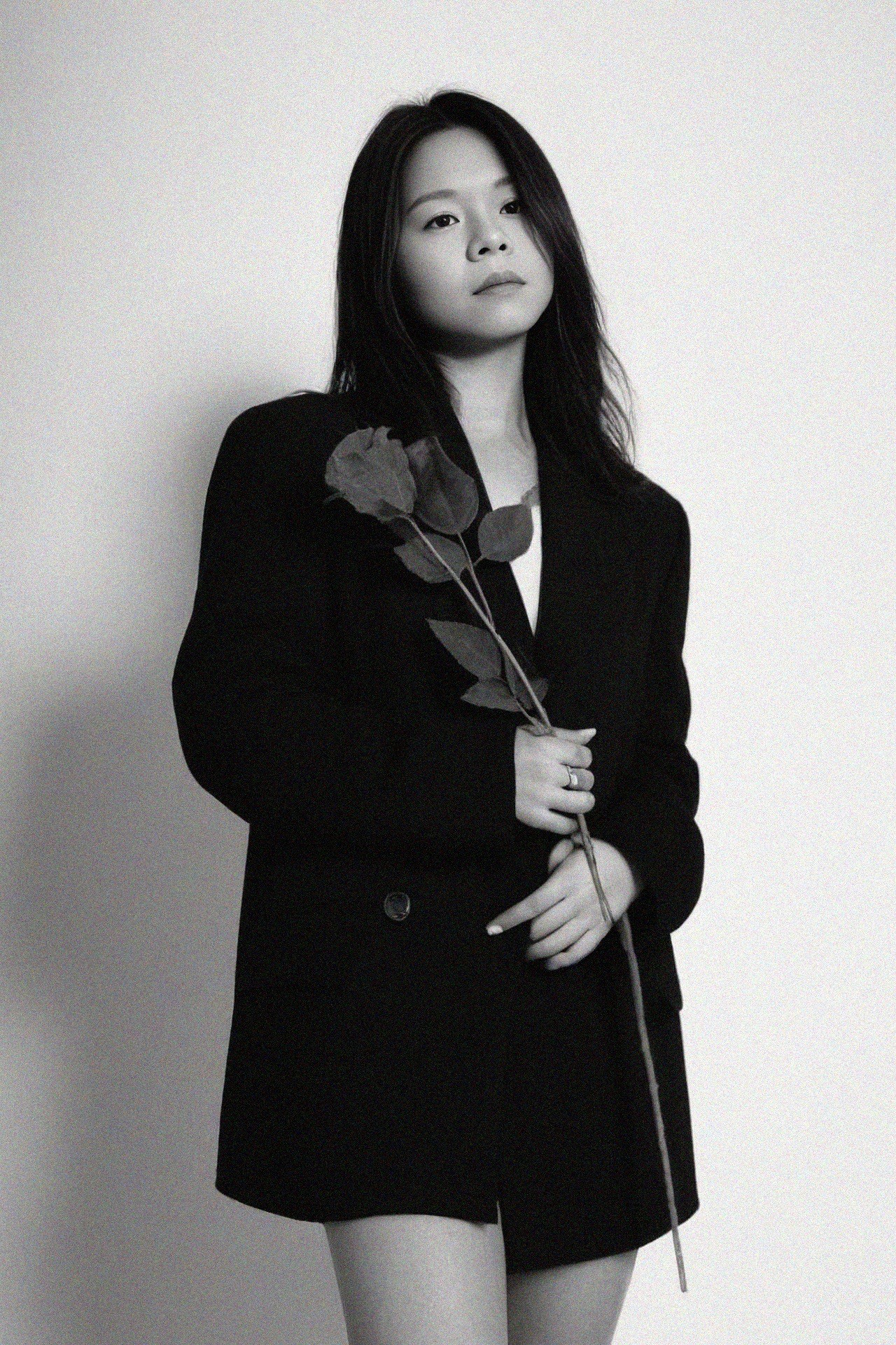 Black and white portrait of a smiling person with curly hair