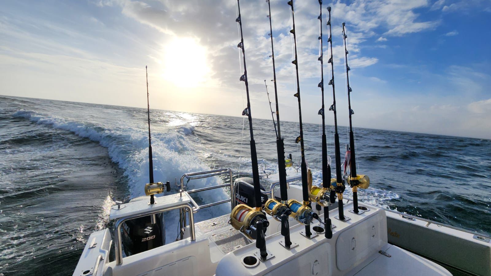 Fishing vessel with rods, reels, and tackle ready for charter.