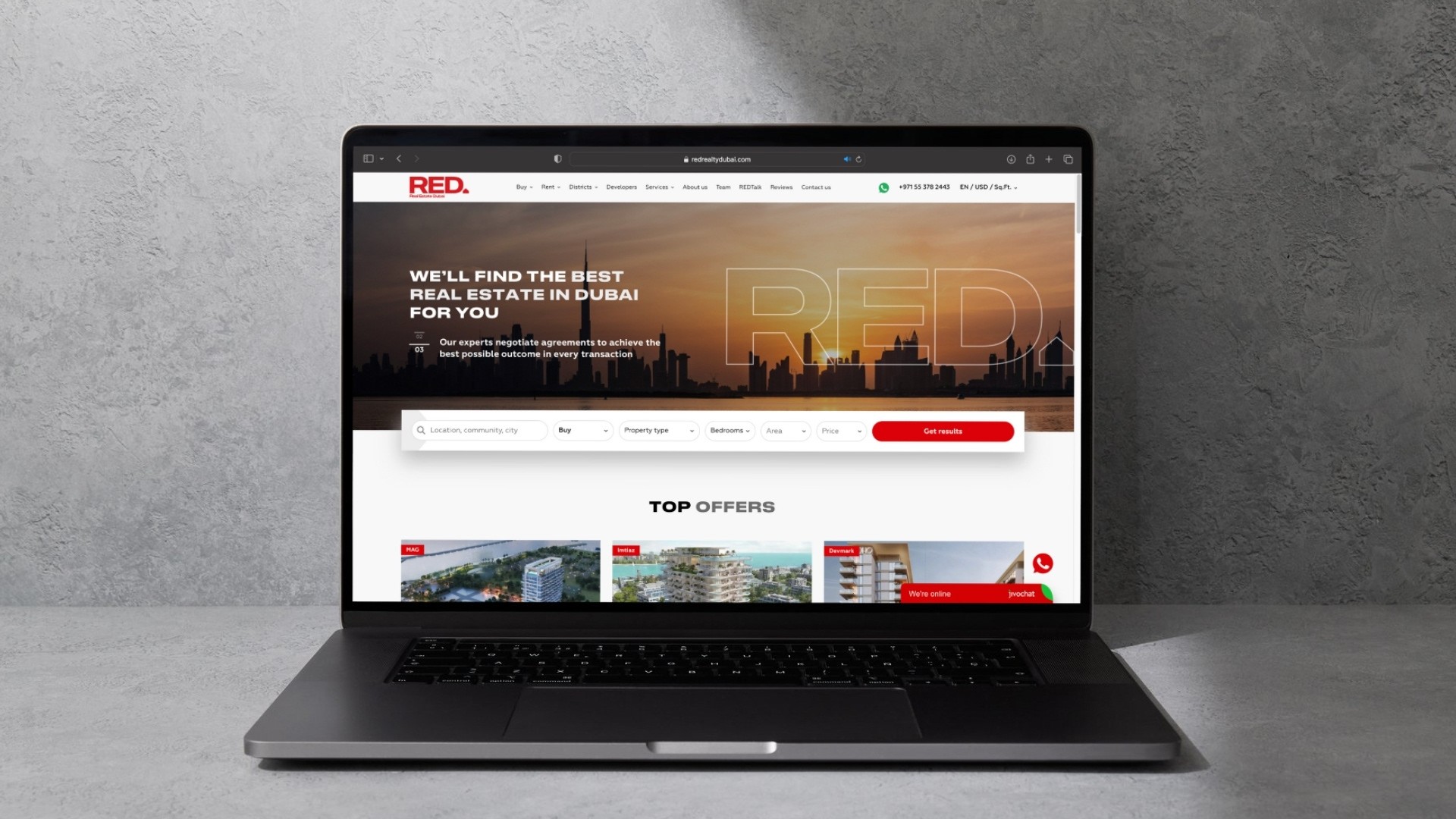 Black-and-white party photo of a smiling man in a check blazer among a crowd.