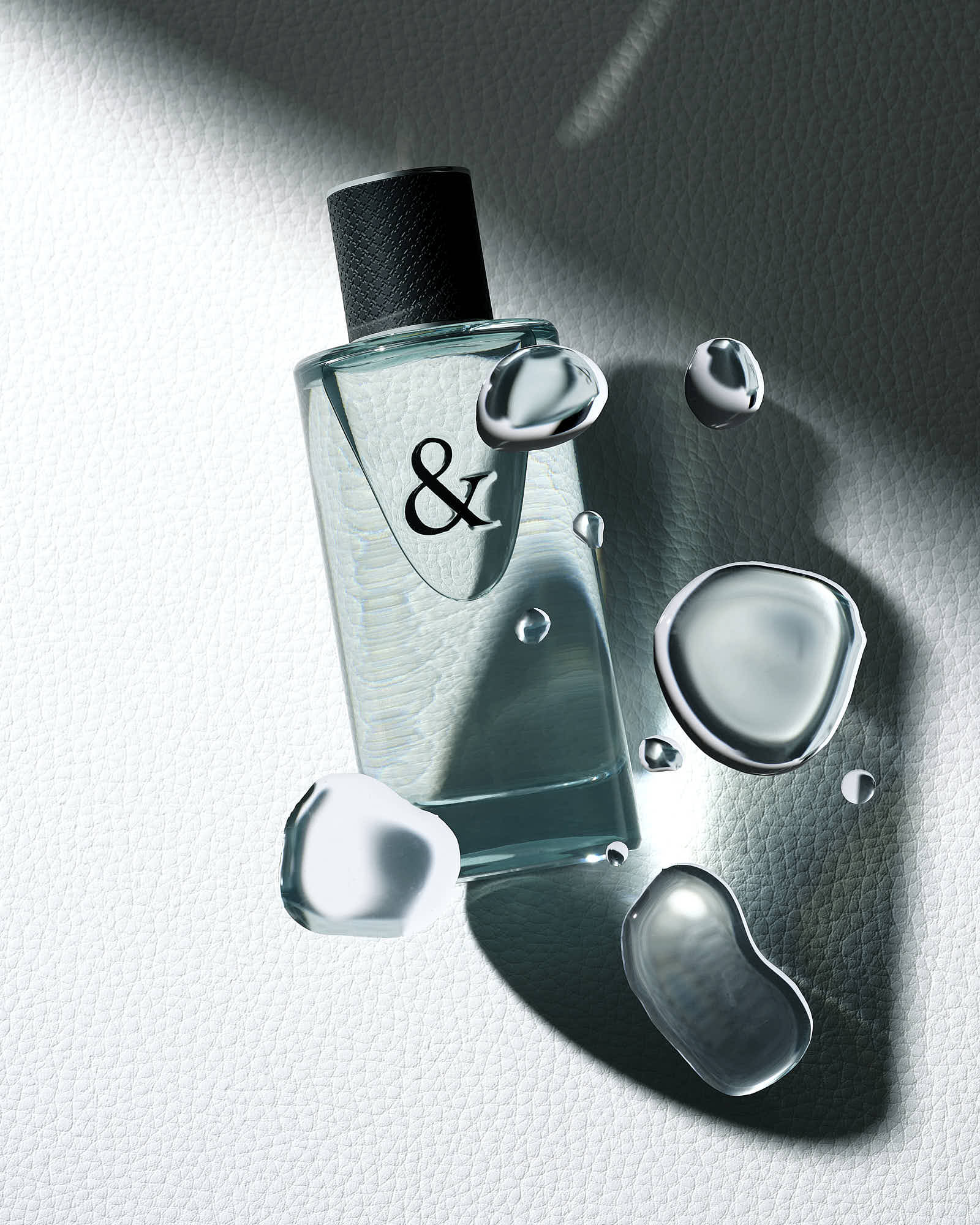 a perfume bottle with strong shadowing and caustic. Droplets of liquid lay over the surface creating difraction