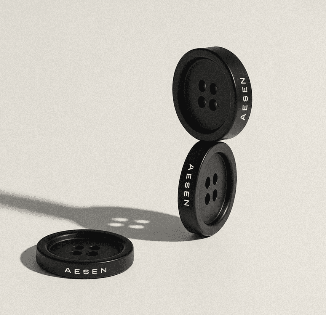 aesen branded garment buttons with engraved wordmark detail