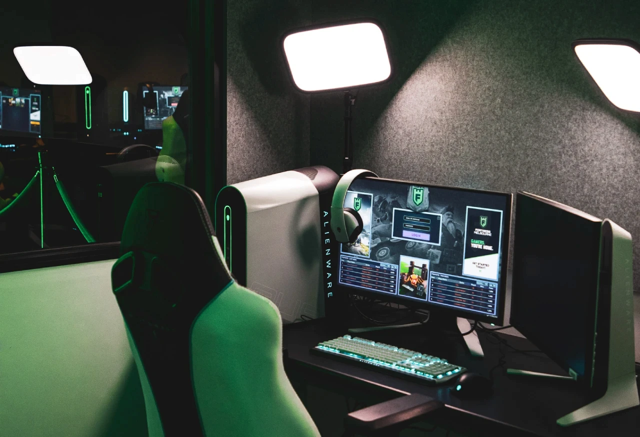 An empty computer chair with the computer turned on in the Streamer Pod at Fortress