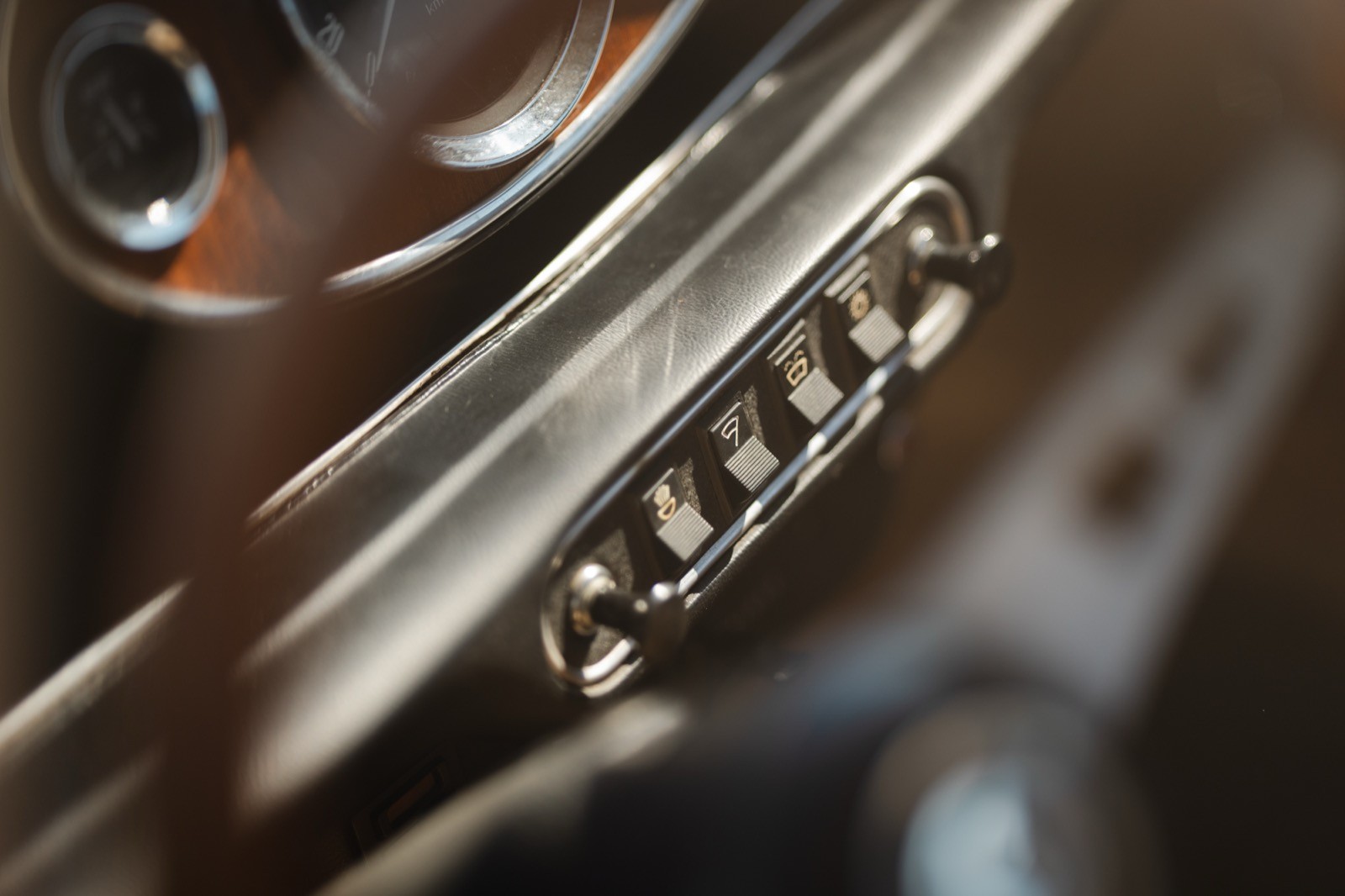 Close-up of a metallic object showing intricate details and textures in brown and silver tones.