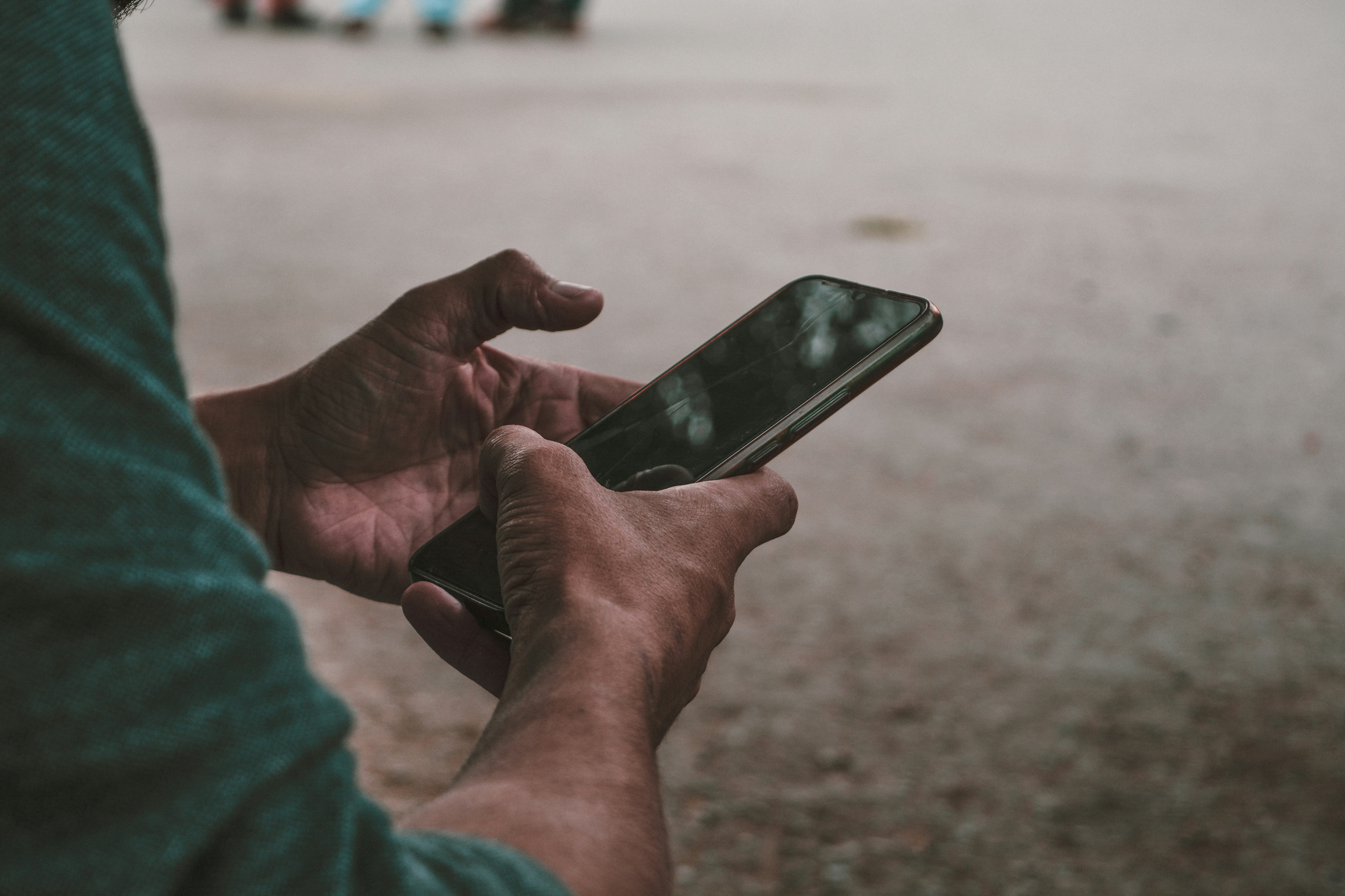 man looking at his mobile - AI Voice Cloning App