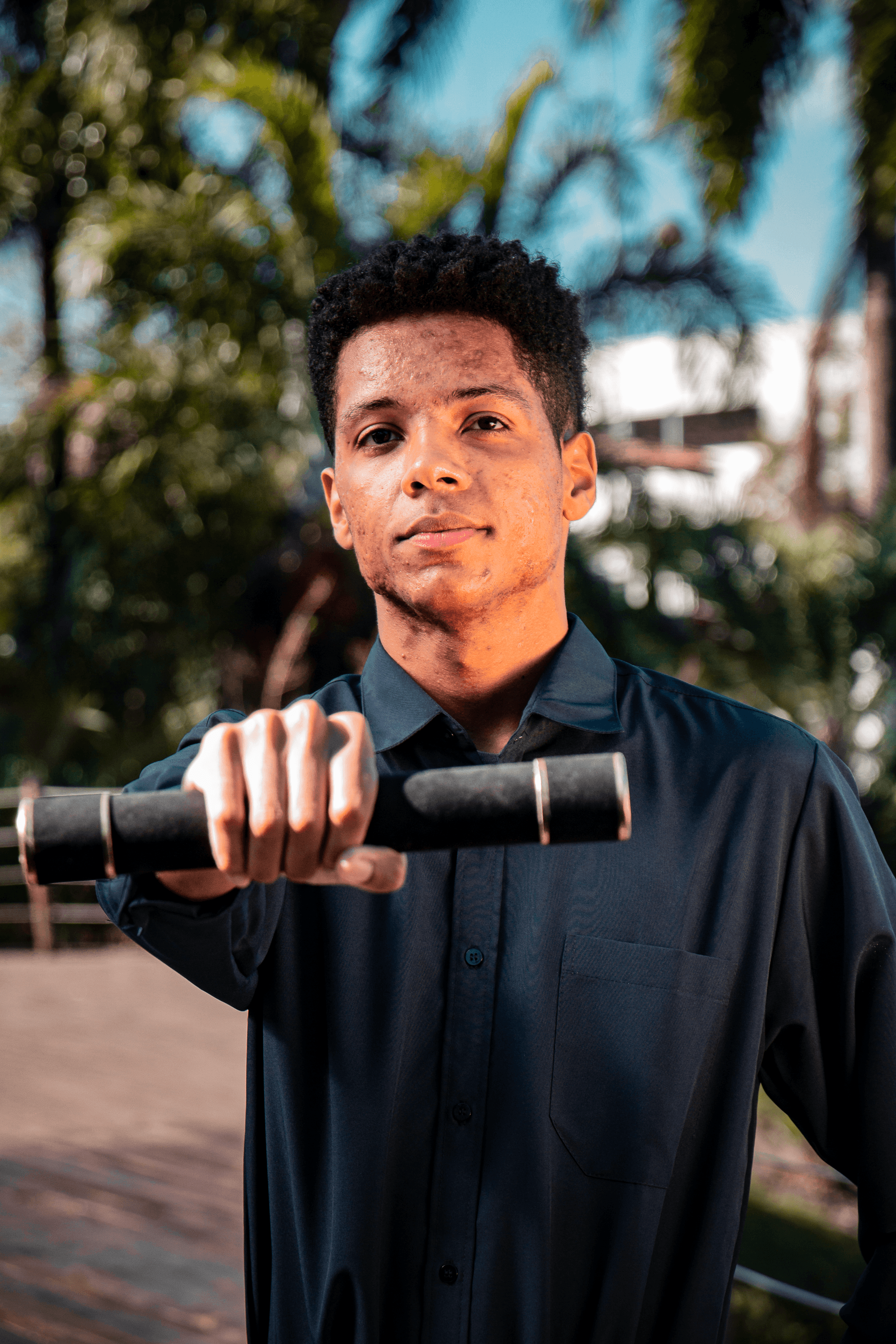 Stylish individual with platinum blonde hair, sunglasses, and leather outfit