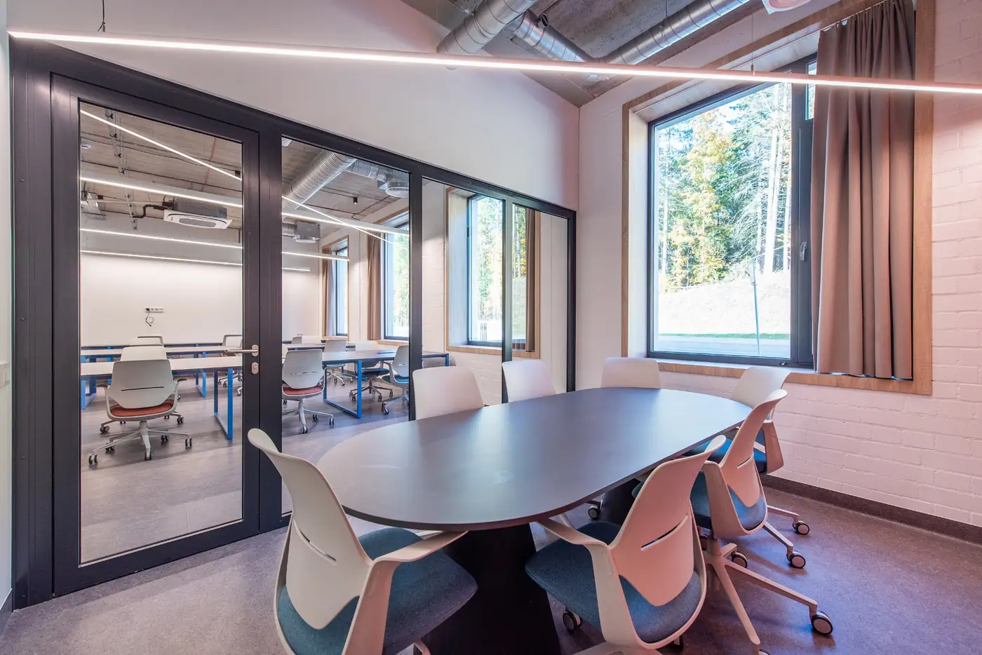 Private meeting and study room in Vilnius student accommodation with a large table and seating.