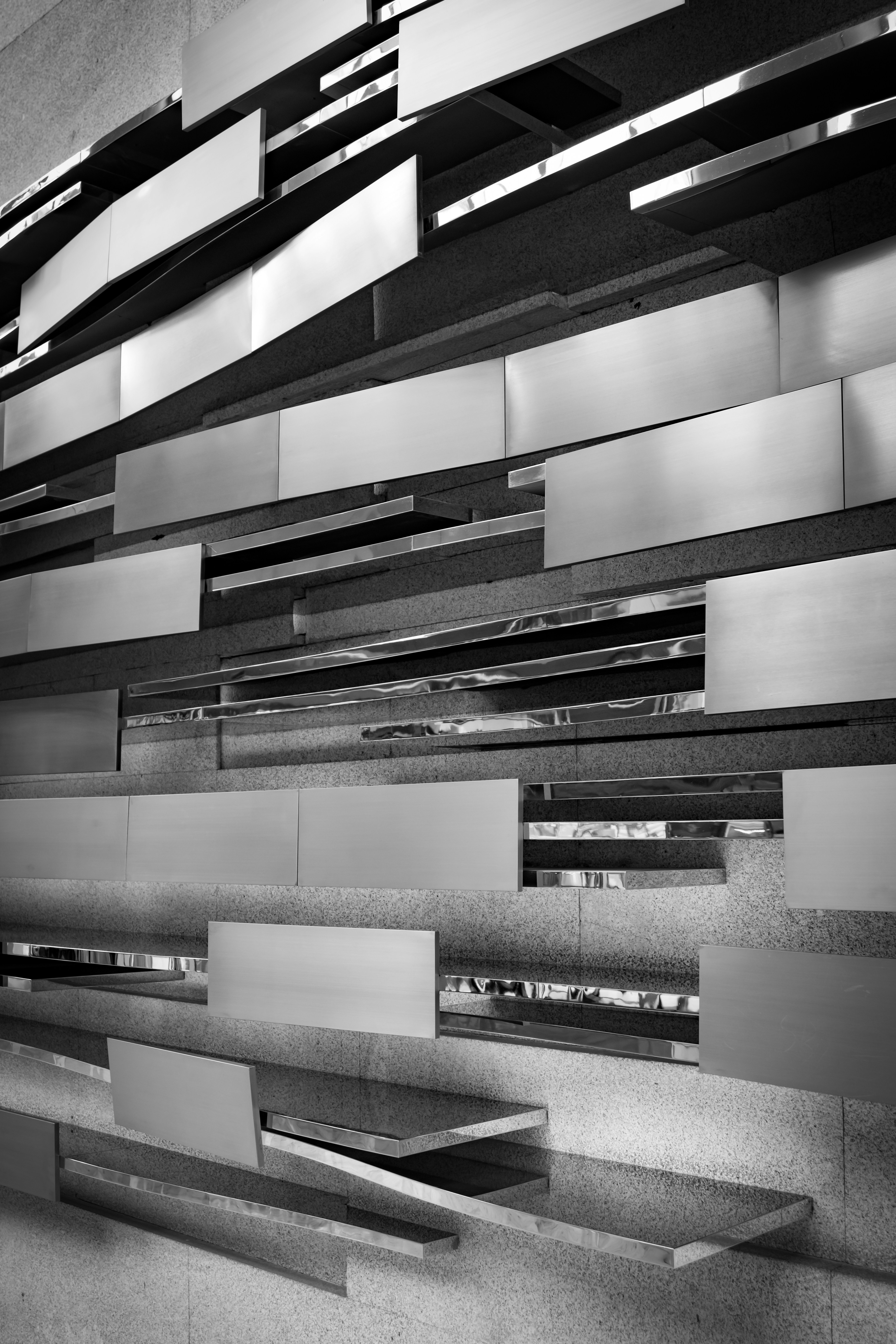 A black and white photo of a bench in a building