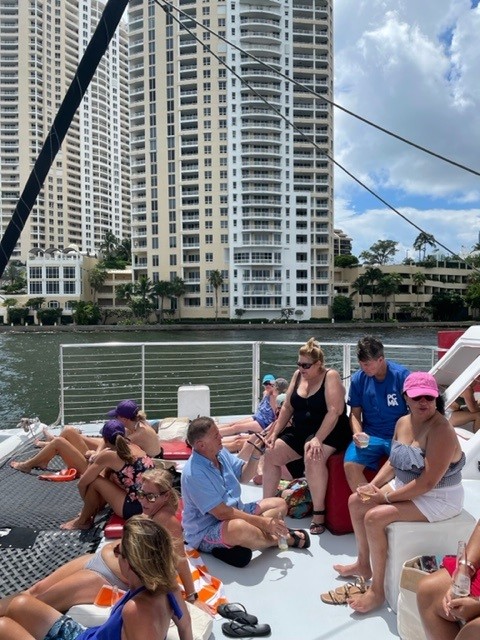 woman in white and red dress standing on green grass field during daytime