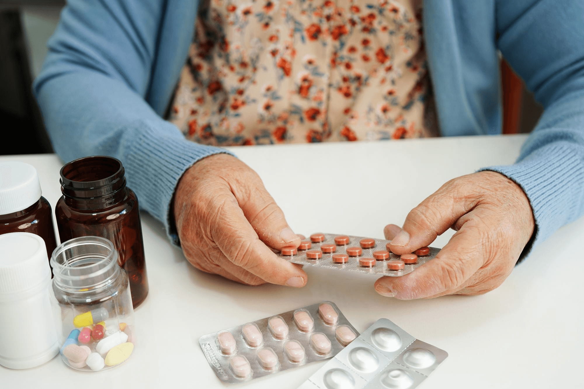 Older adult managing multiple prescription medications at home