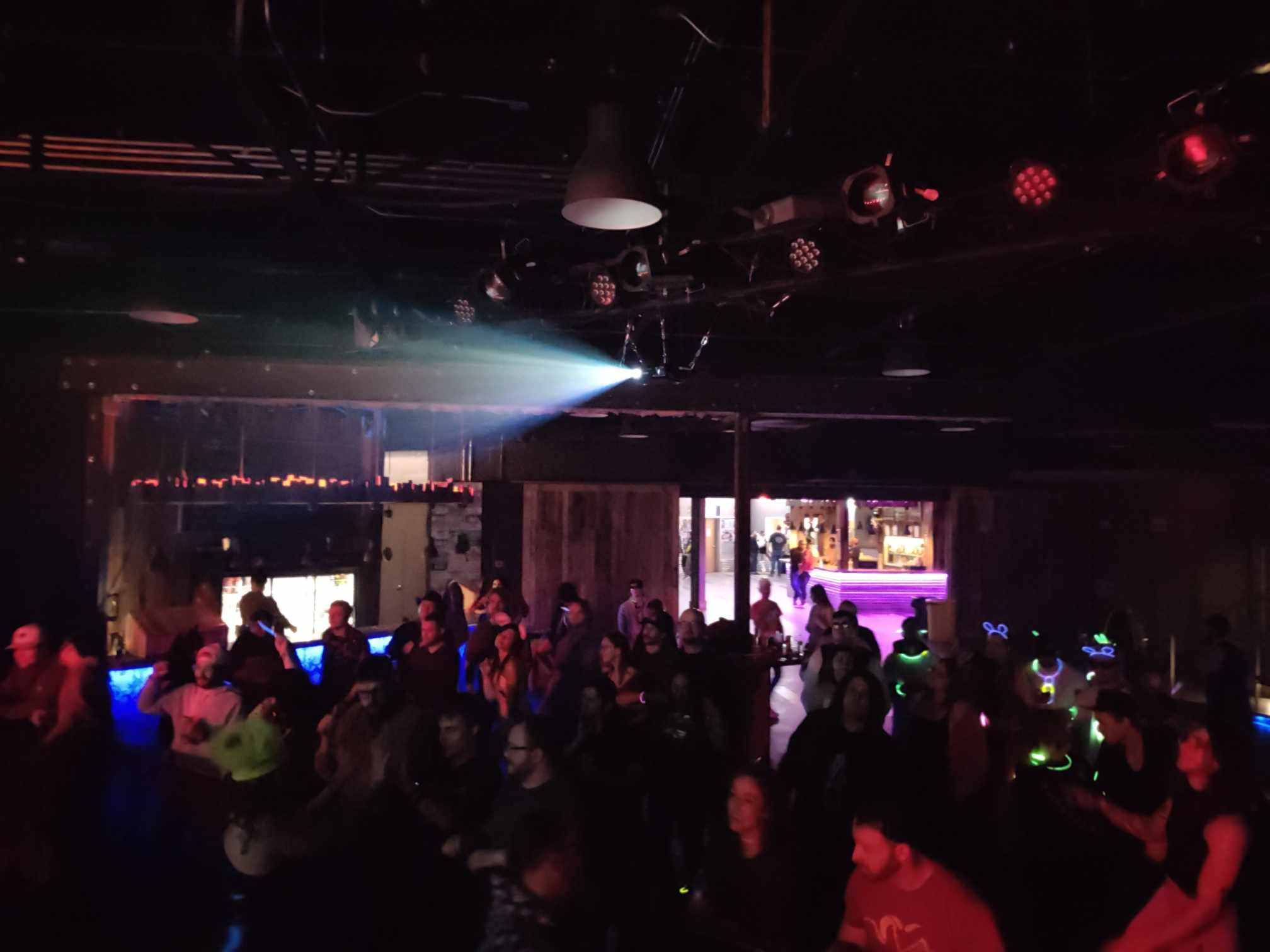 Nightclub crowd beneath a beam of light