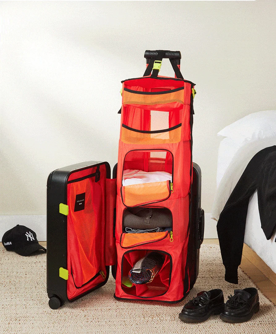Integrated closet system with bold colourway inside MoMA × Solgaard luggage