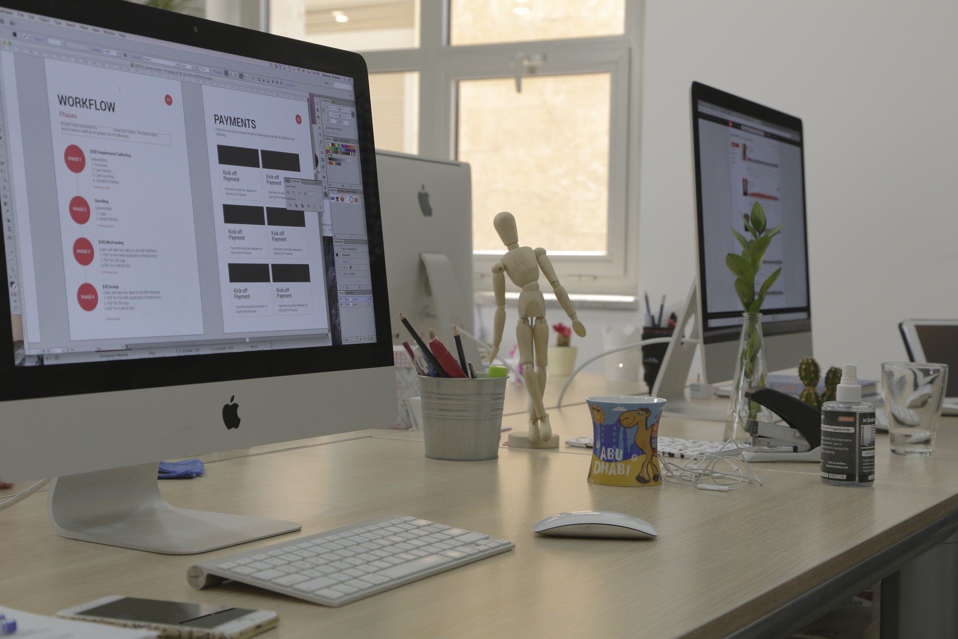 Product design screens displayed on workstations inside Plexable's Amman office