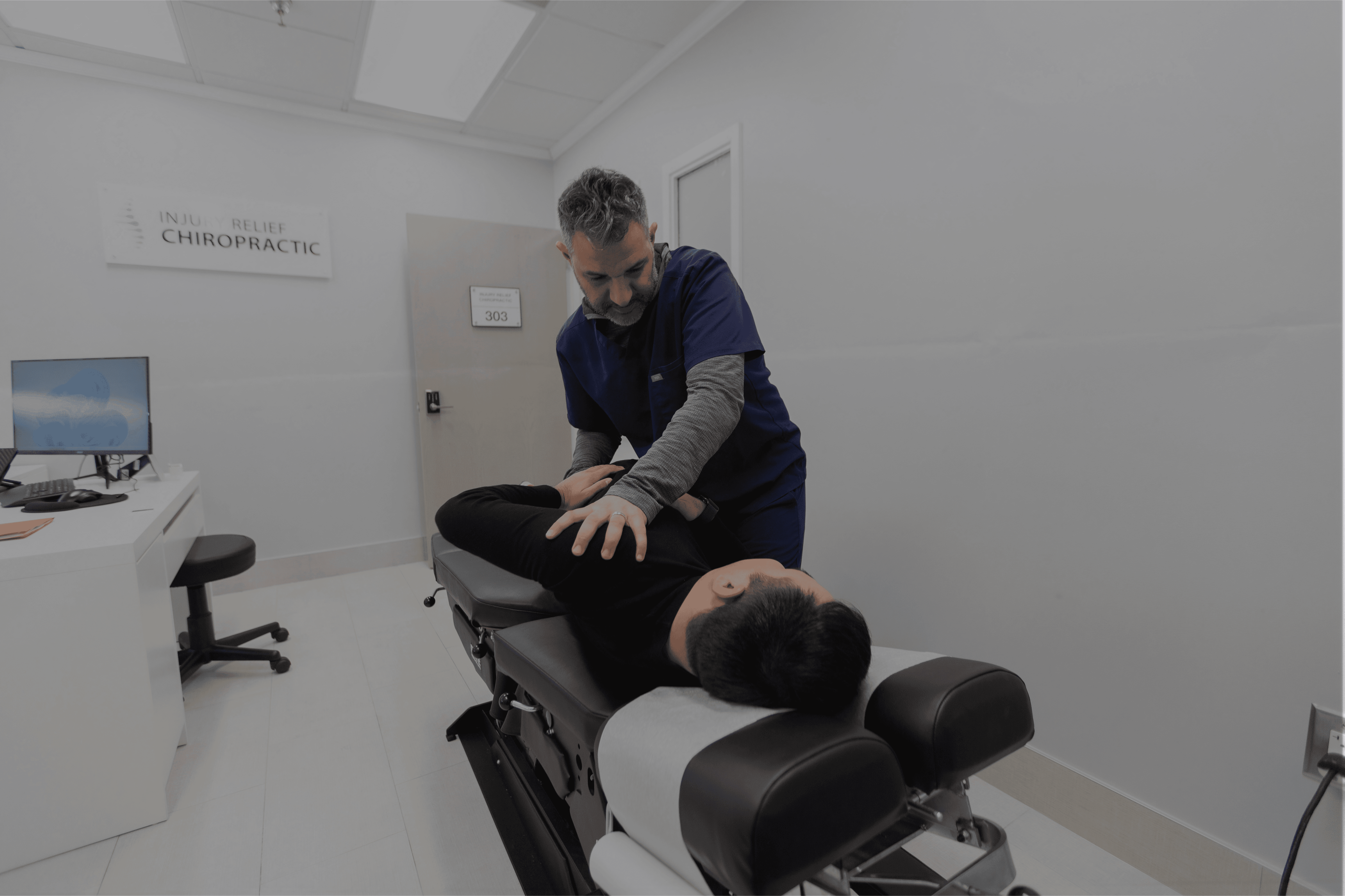 person massaging the back of a woman