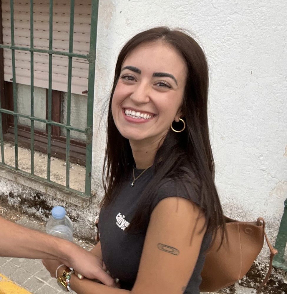 A smiling happy customer with curly hair on a blue background
