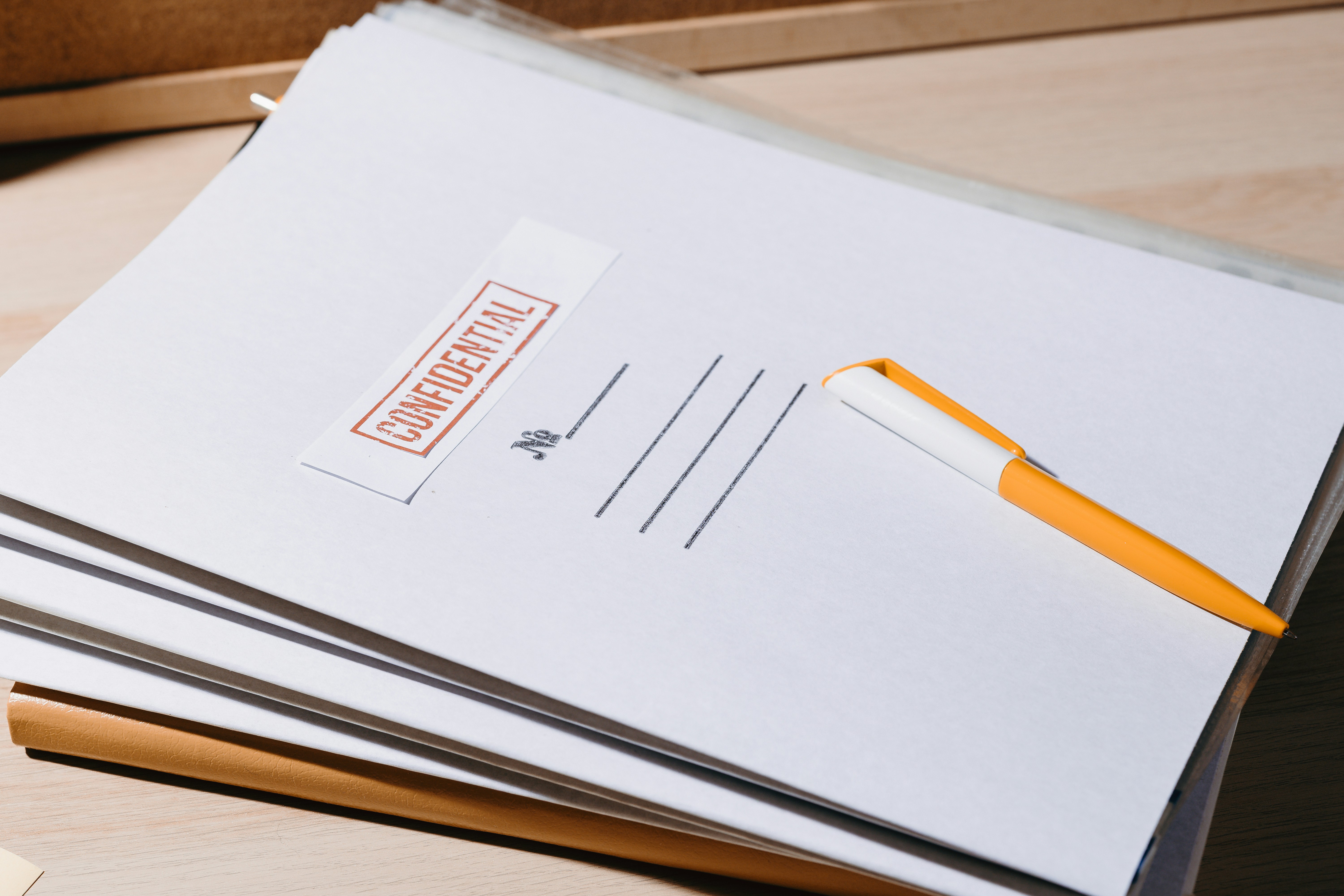 a pile of documents marked confidential