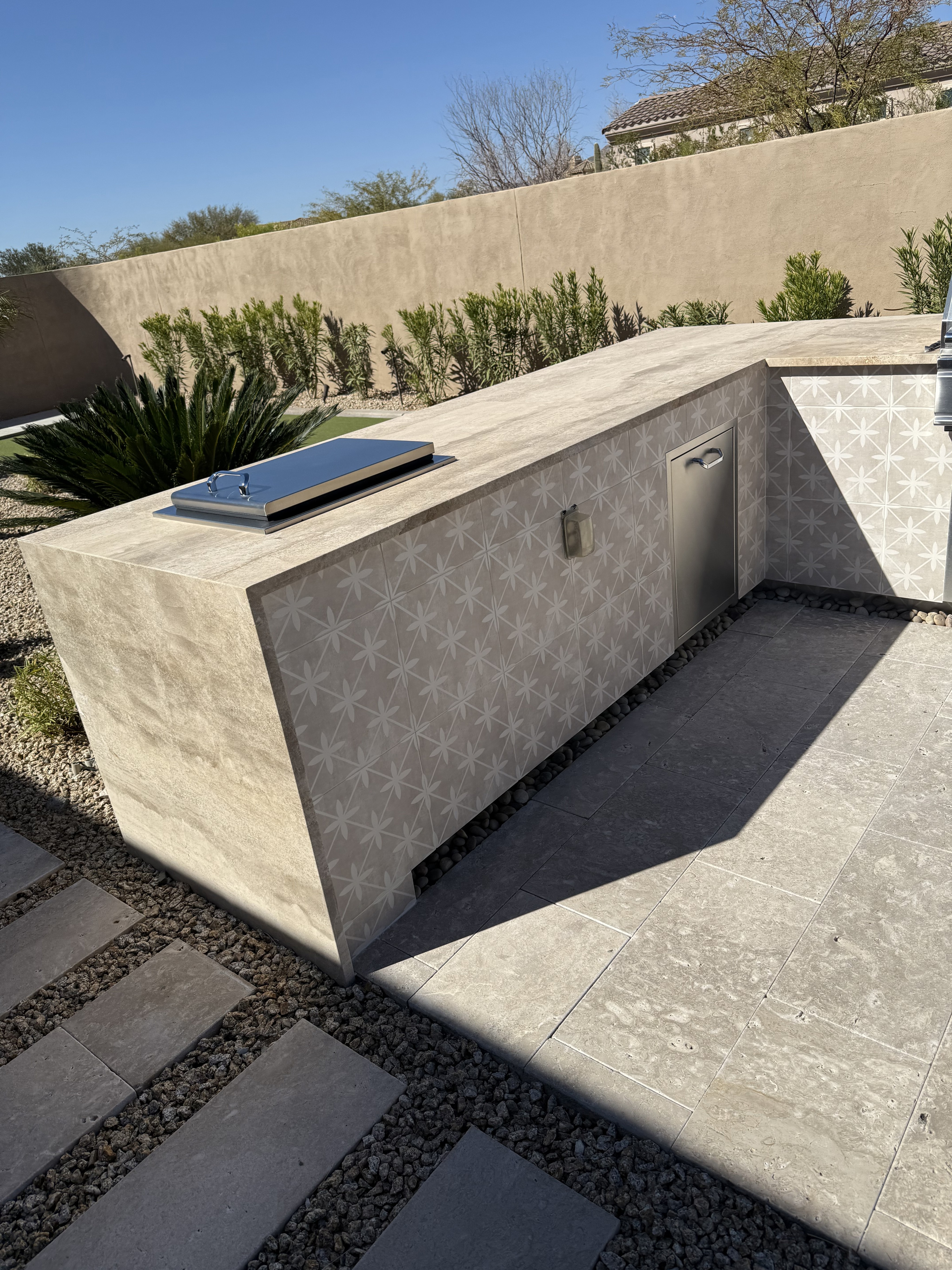 Stylish bathroom featuring a black and white hexagonal tile pattern covering the walls and a toilet.