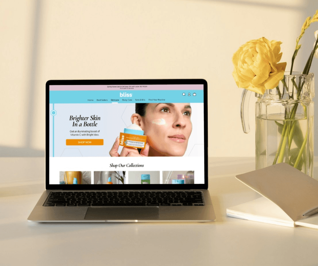 Image showing the Desktop homepage for Bliss depicting a model holding a moisturizer