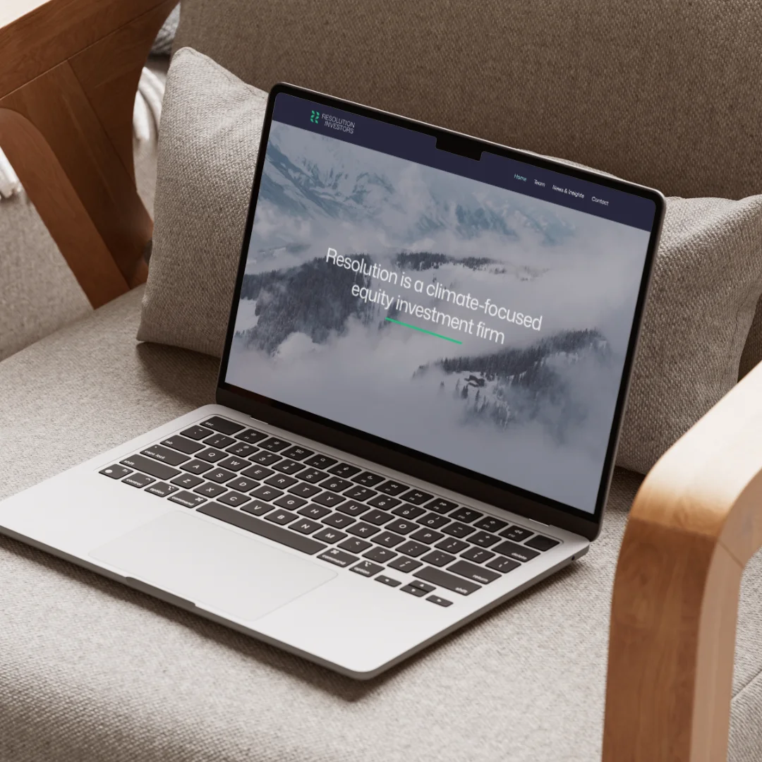 Red trolley car driving down a tree-lined street.