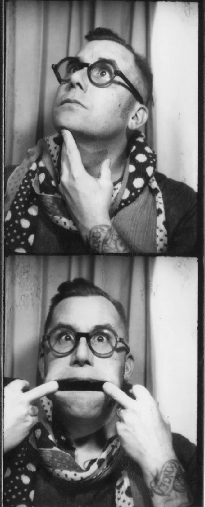 Rob Harrigan wearing glasses and a polka-dotted scarf poses humorously in a photo booth, making playful faces.