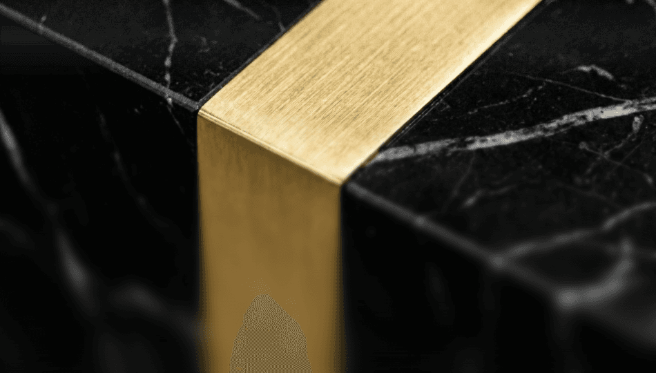 Macro photography of brushed gold metal meeting black marble