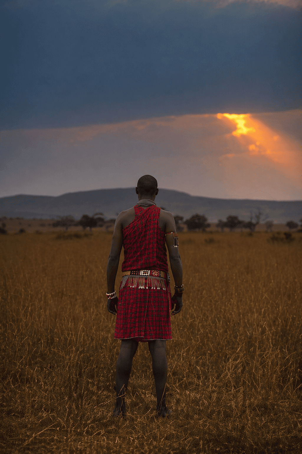 A Masai tribe individual enjoying the sunset after a hard day of hunt and work