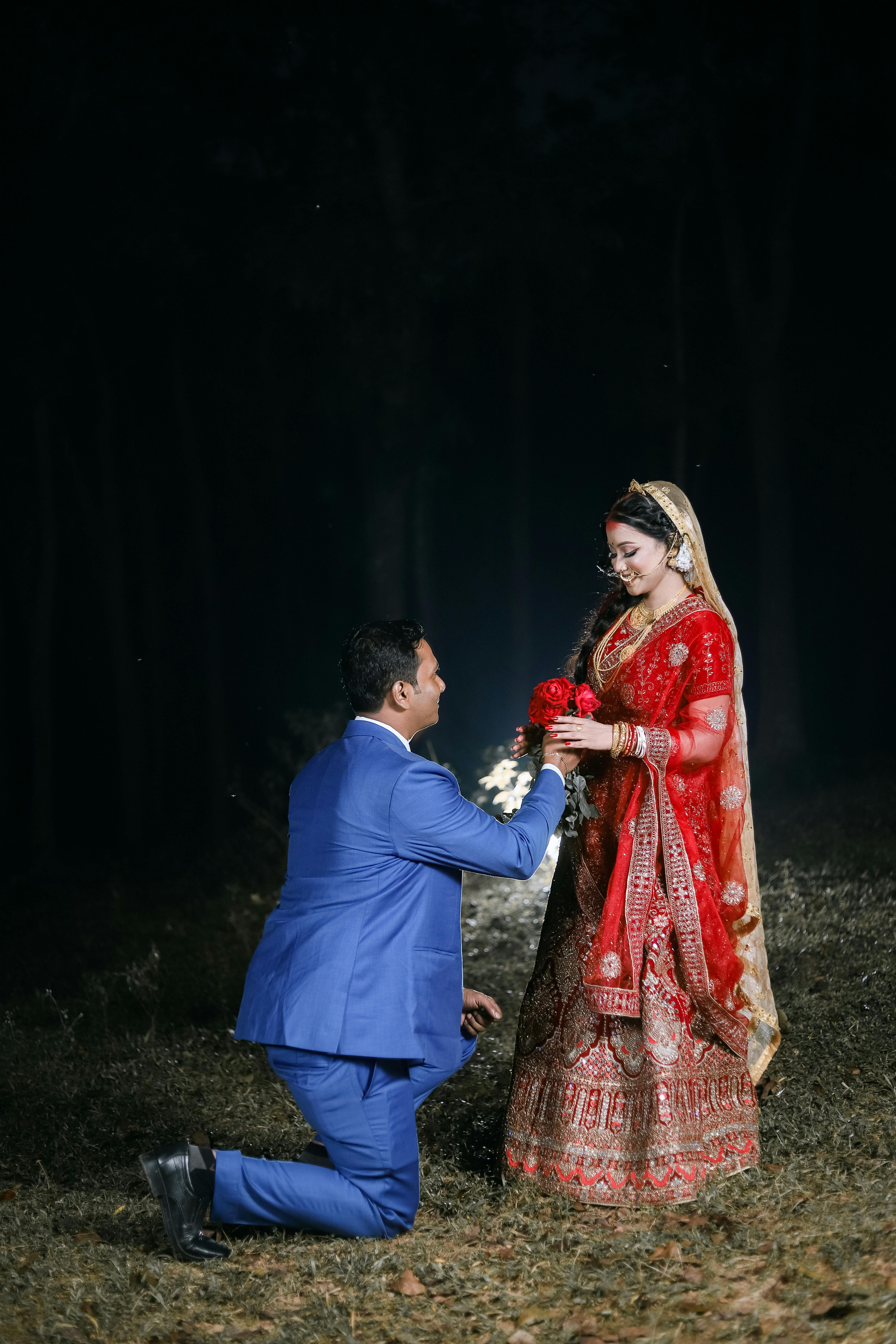 Modern bathroom featuring a walk-in shower, wooden vanity, round mirror, and elegant marble tiles.