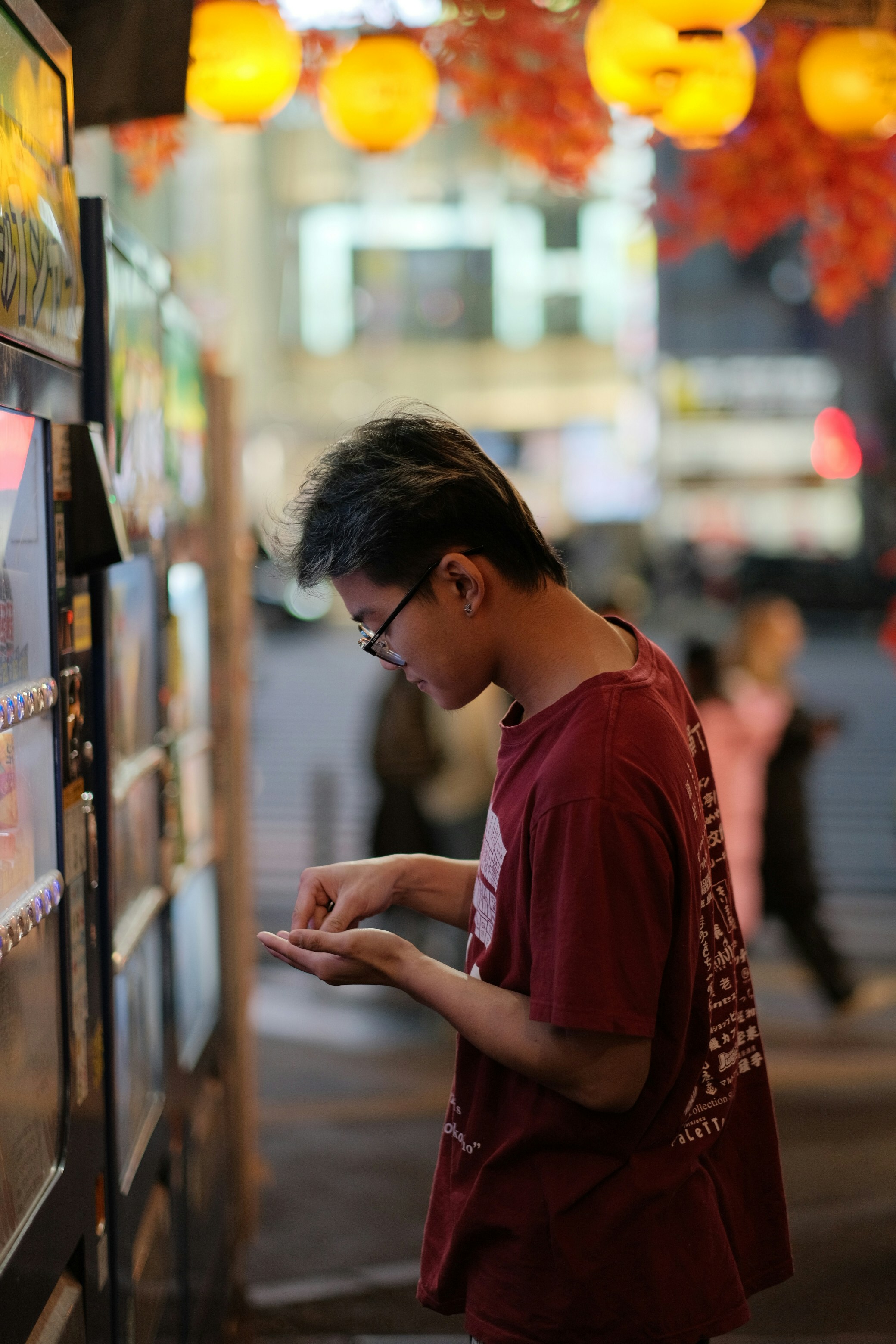 A man standing next to a vending machine
